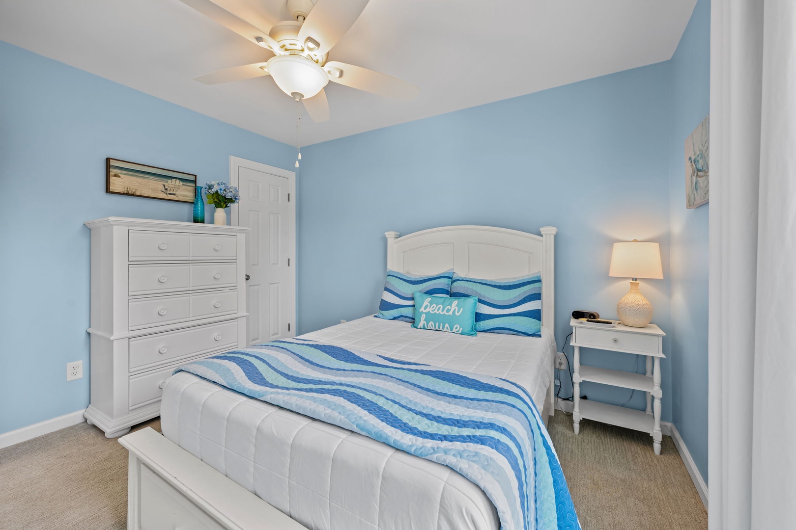 Drift off to peaceful dreams in your cozy coastal retreat, where ocean-inspired blues and crisp white linens create the perfect seaside sanctuary.