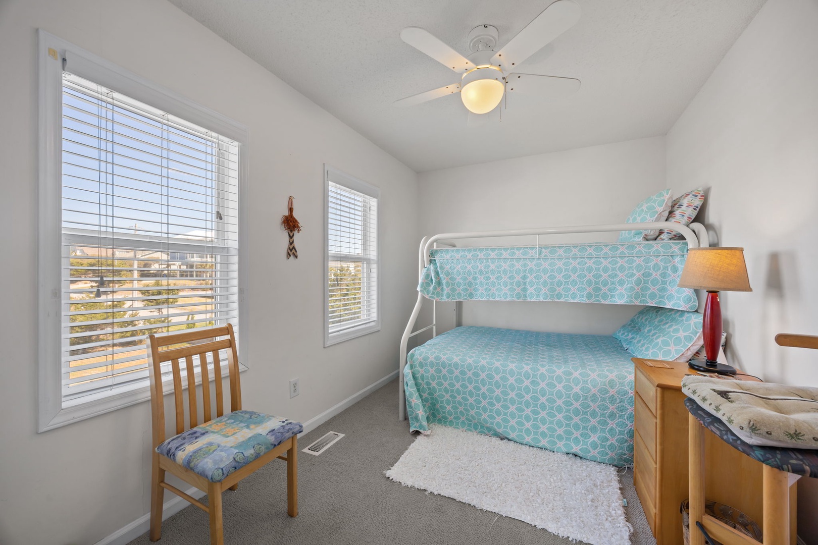 Cozy kids' room with cheerful turquoise bunk beds where your little ones will drift off to sleep after beach adventures.
