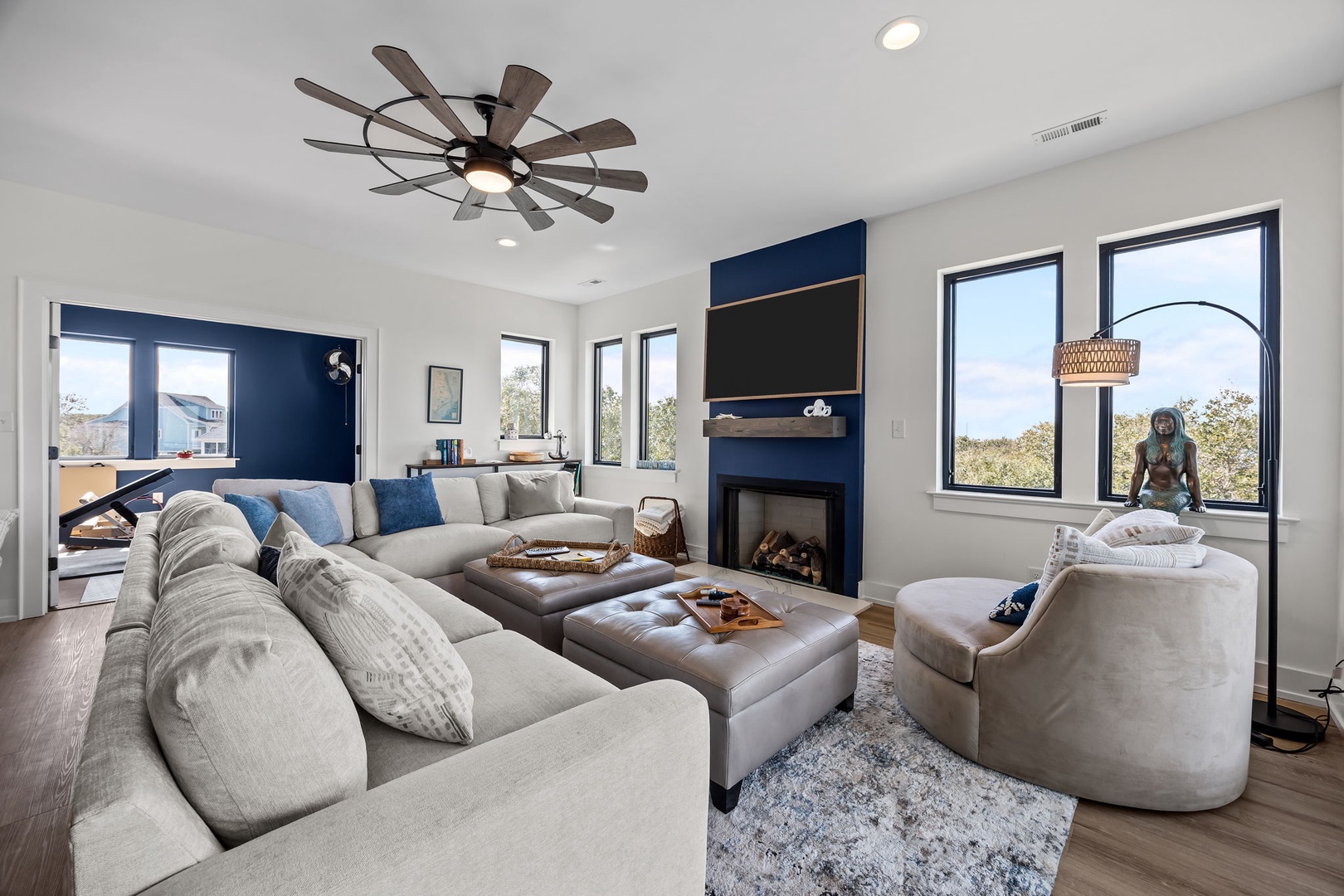 Sink into plush sectional seating while your favorite show plays on the wall-mounted TV, with a cozy fireplace nearby.