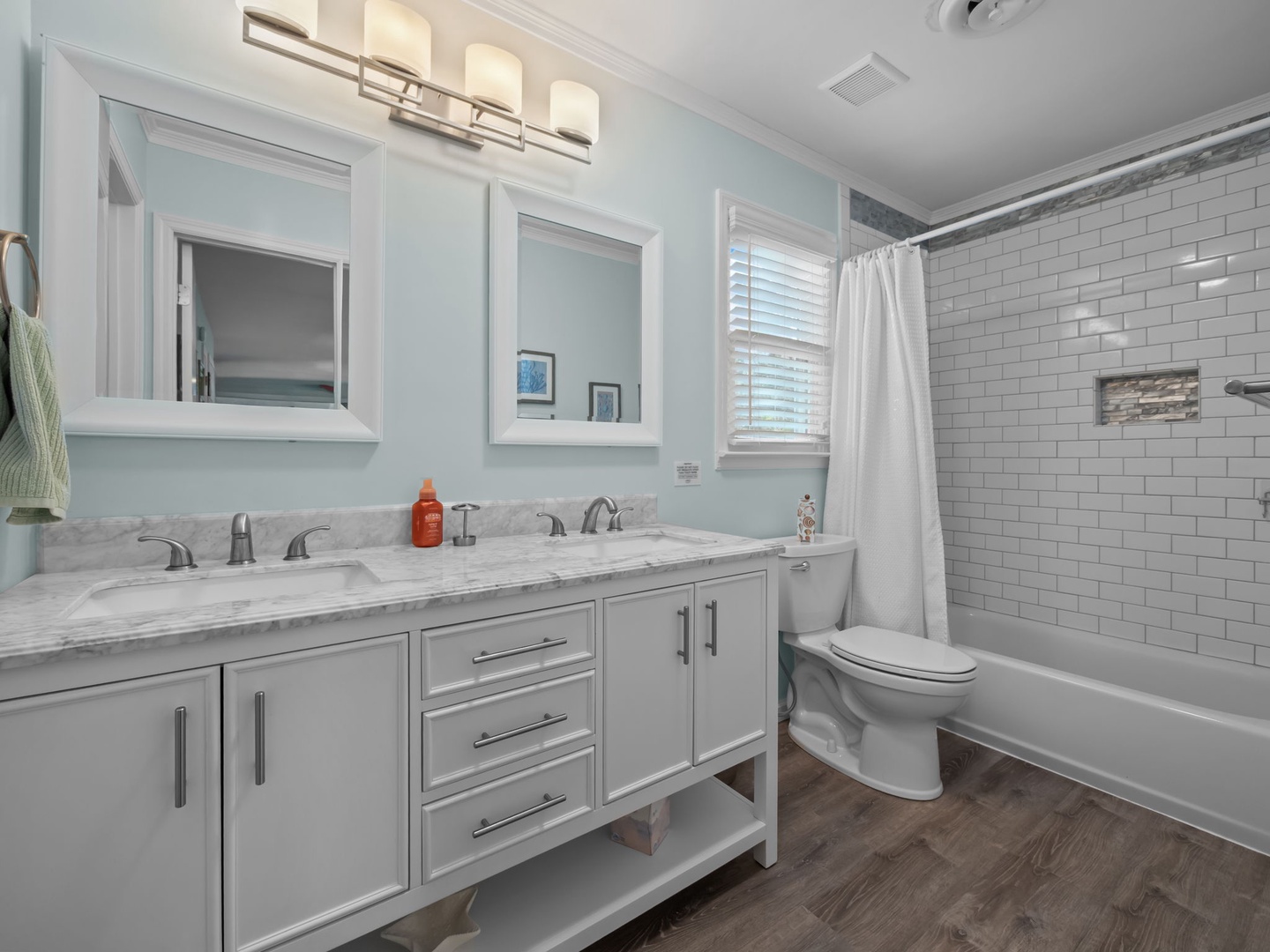 Refresh in your elegant bathroom featuring marble countertops, dual vanities, and a subway-tiled tub for relaxing soaks.
