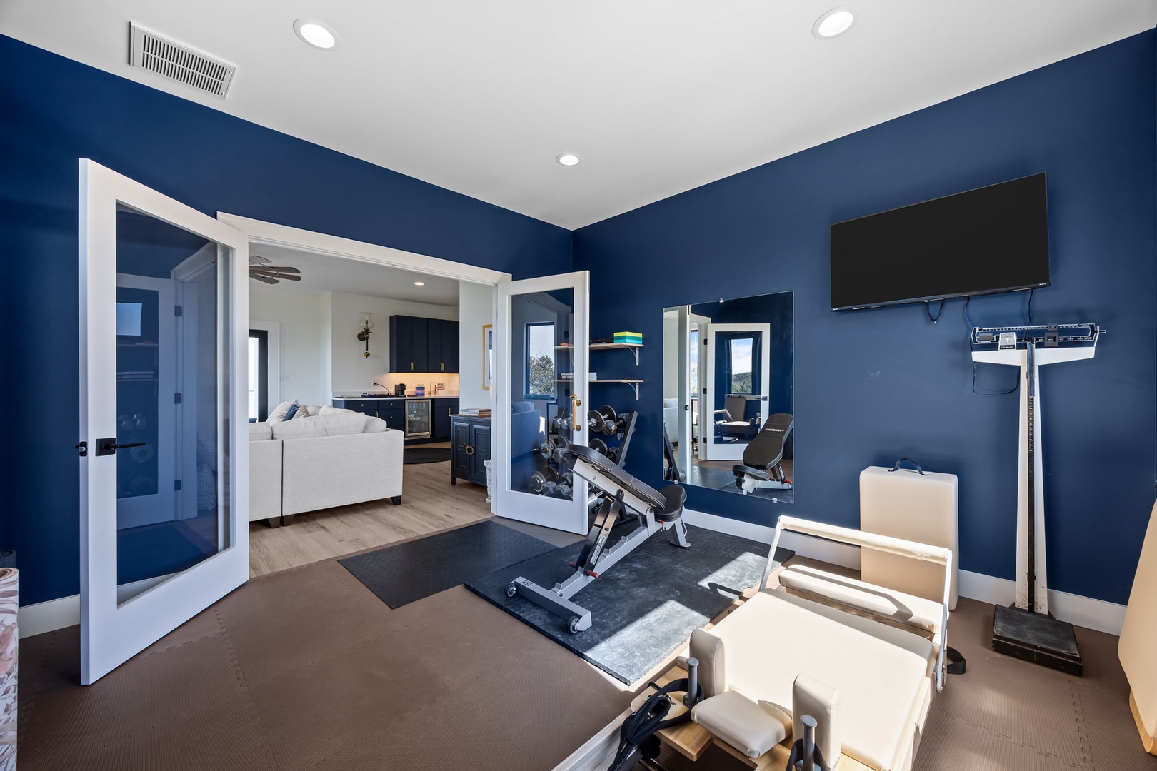 Your private fitness sanctuary awaits with professional equipment and inspiring blue walls to energize your workout routine.