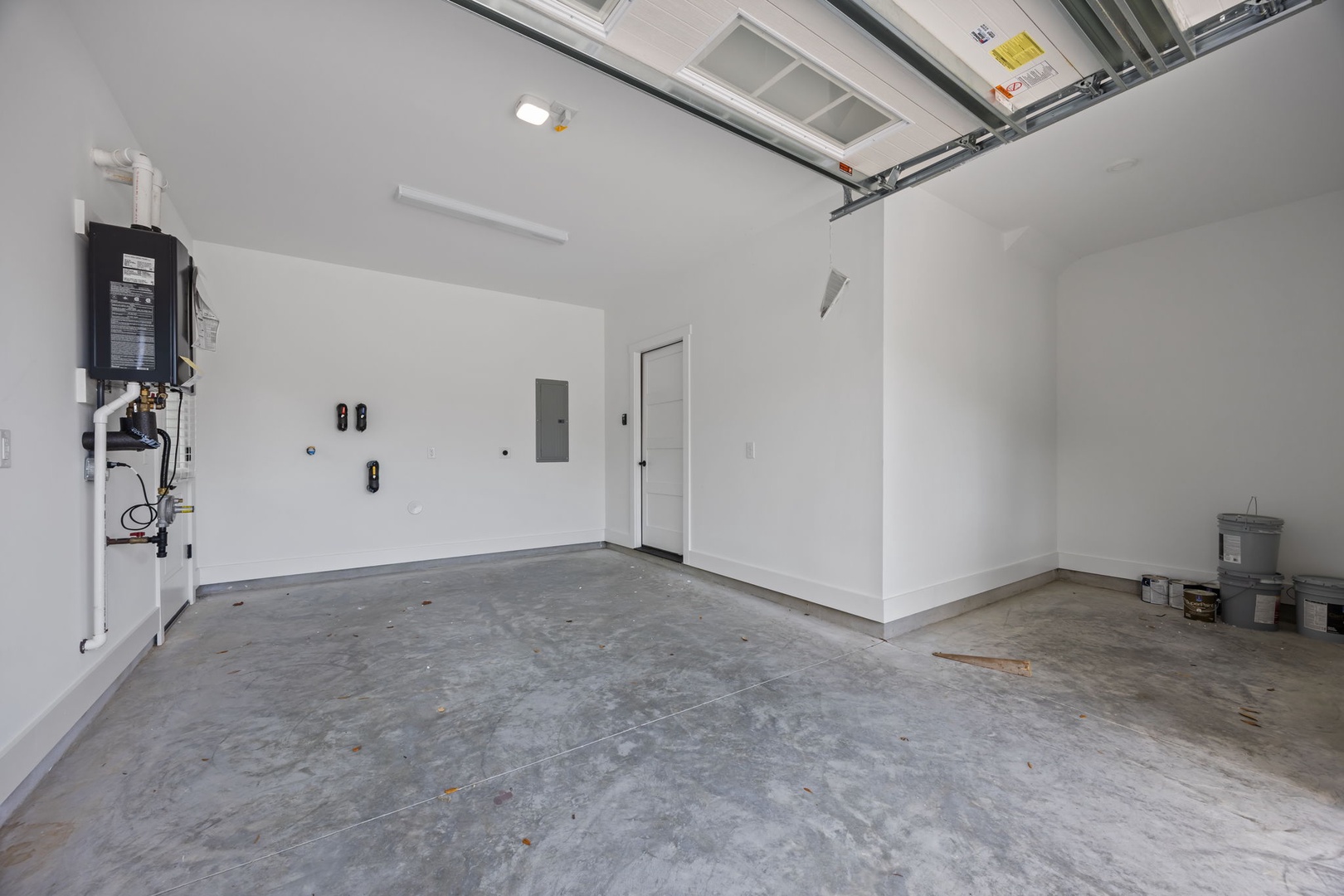 Spacious garage with clean walls and concrete flooring provides convenient parking for your vehicle during your stay.