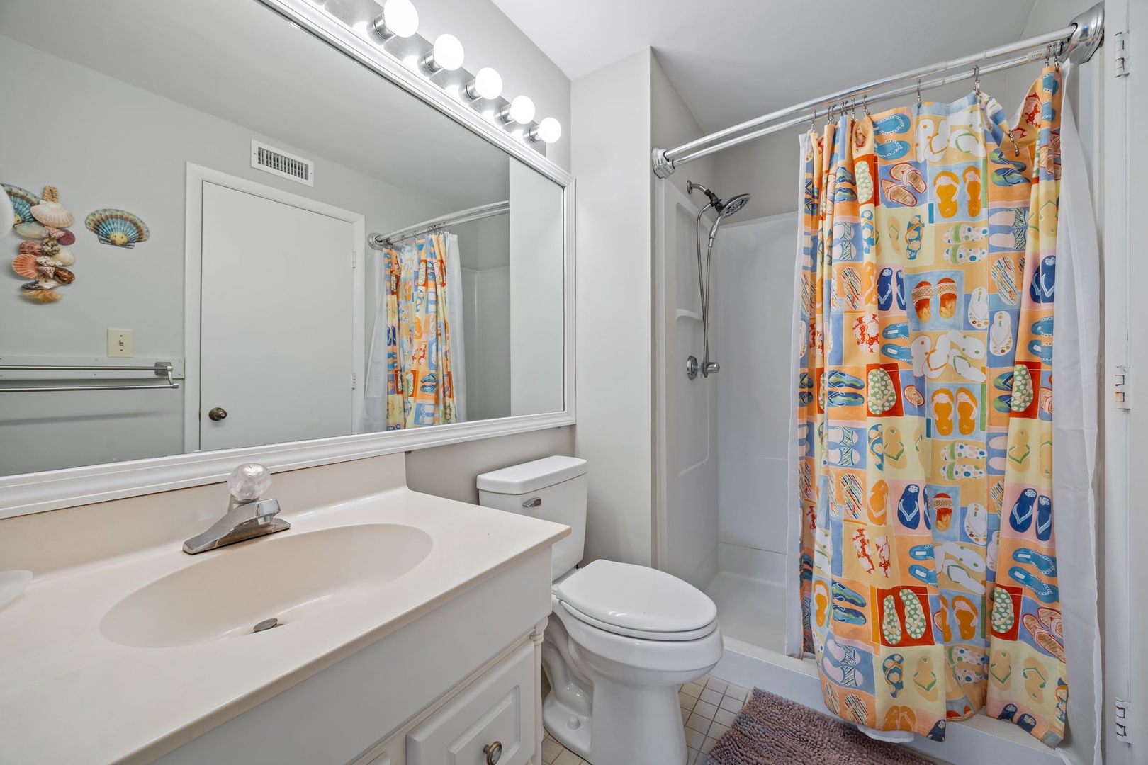 Freshen up in your bright, cheerful bathroom with playful beach-themed touches and all the essentials for a comfortable stay.