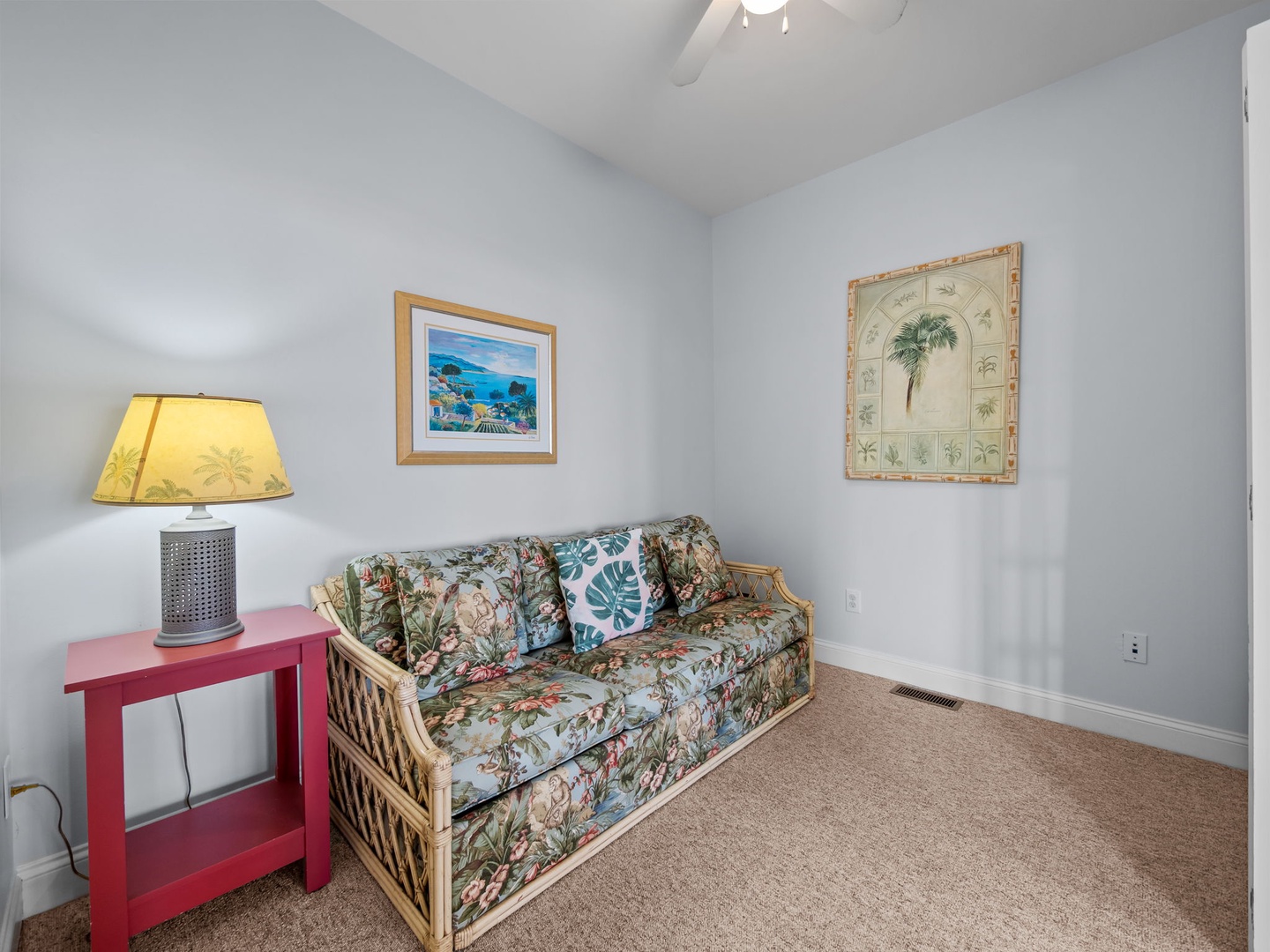 Sink into tropical comfort on your woven sofa, where beach-themed art and soft lighting create your perfect island retreat.