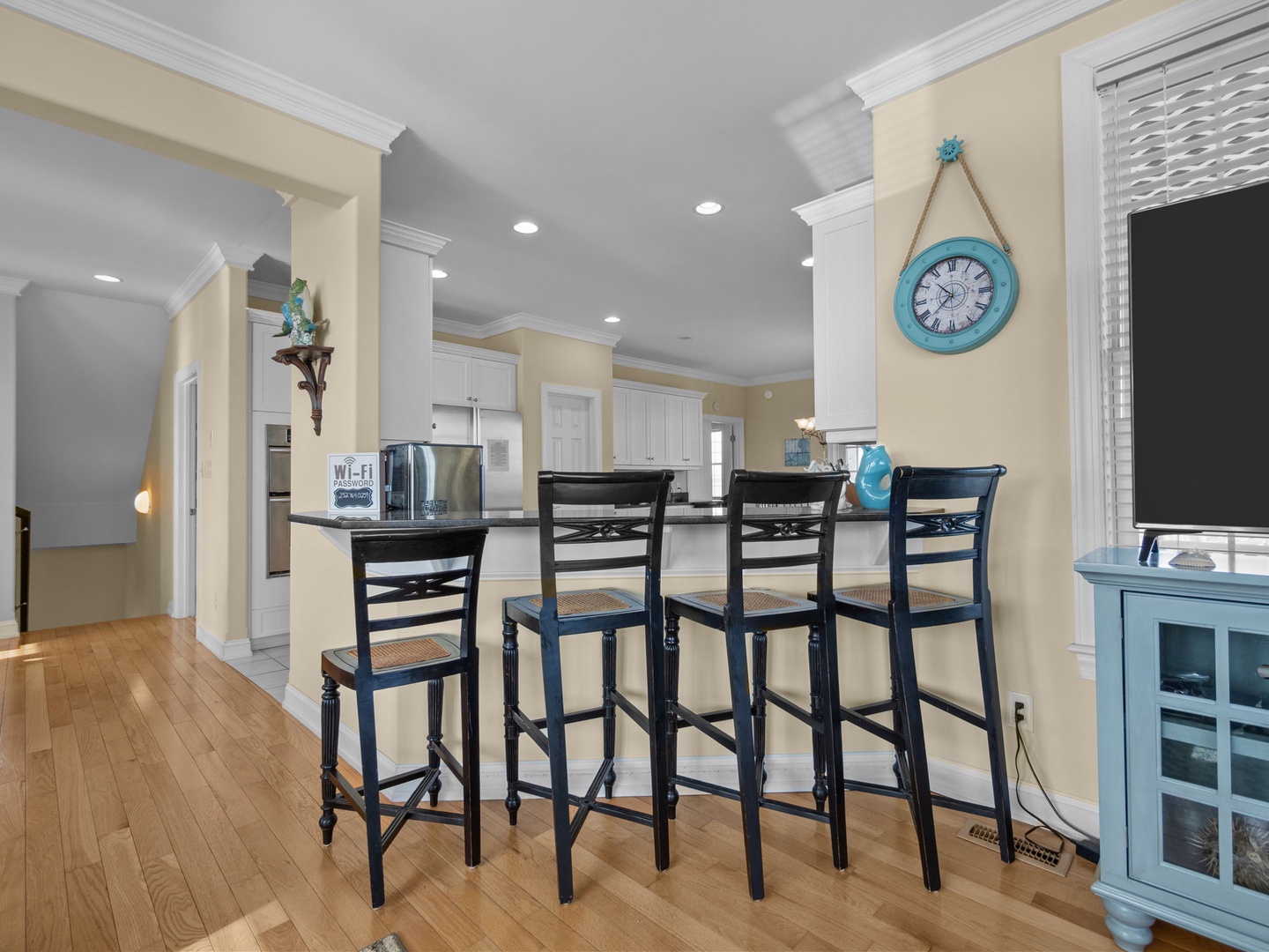 Gather around your beautiful breakfast bar with elegant seating for four, perfect for morning coffee or casual meals in this bright, welcoming space.