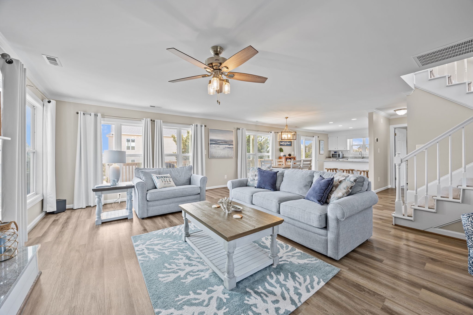 Relax in this bright, open living space where soft coastal colors and plush seating create your perfect retreat.