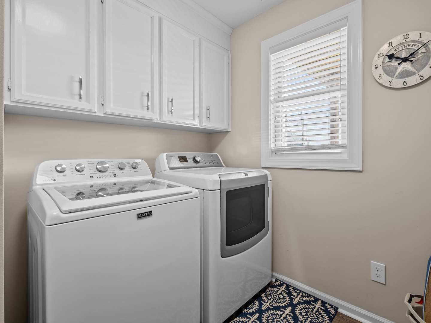 Your dedicated laundry room features full-size washer and dryer with convenient upper cabinets for storage.