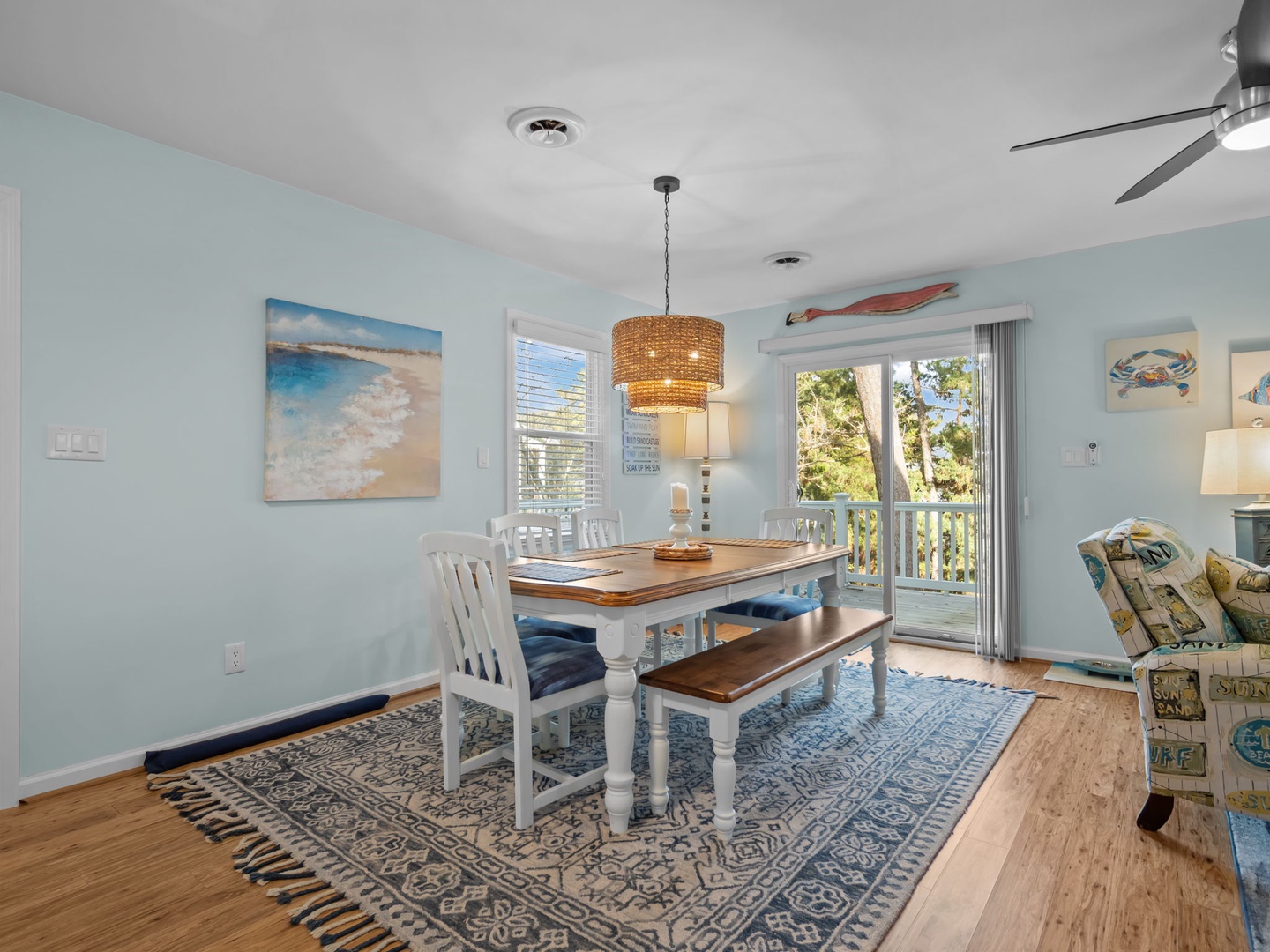 Gather around this inviting dining table where coastal charm meets comfort. Natural light streams through your private balcony doors, perfect for memorable meals together.