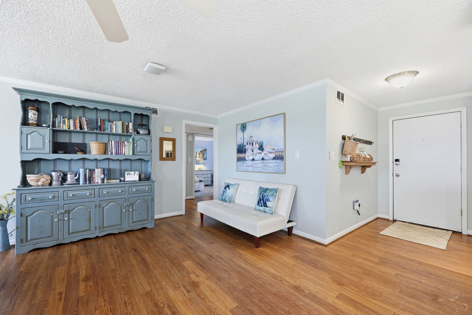 Settle into a cozy living space with coastal charm and a sofa where you can unwind after your adventures, surrounded by thoughtful décor that makes you feel right at home.