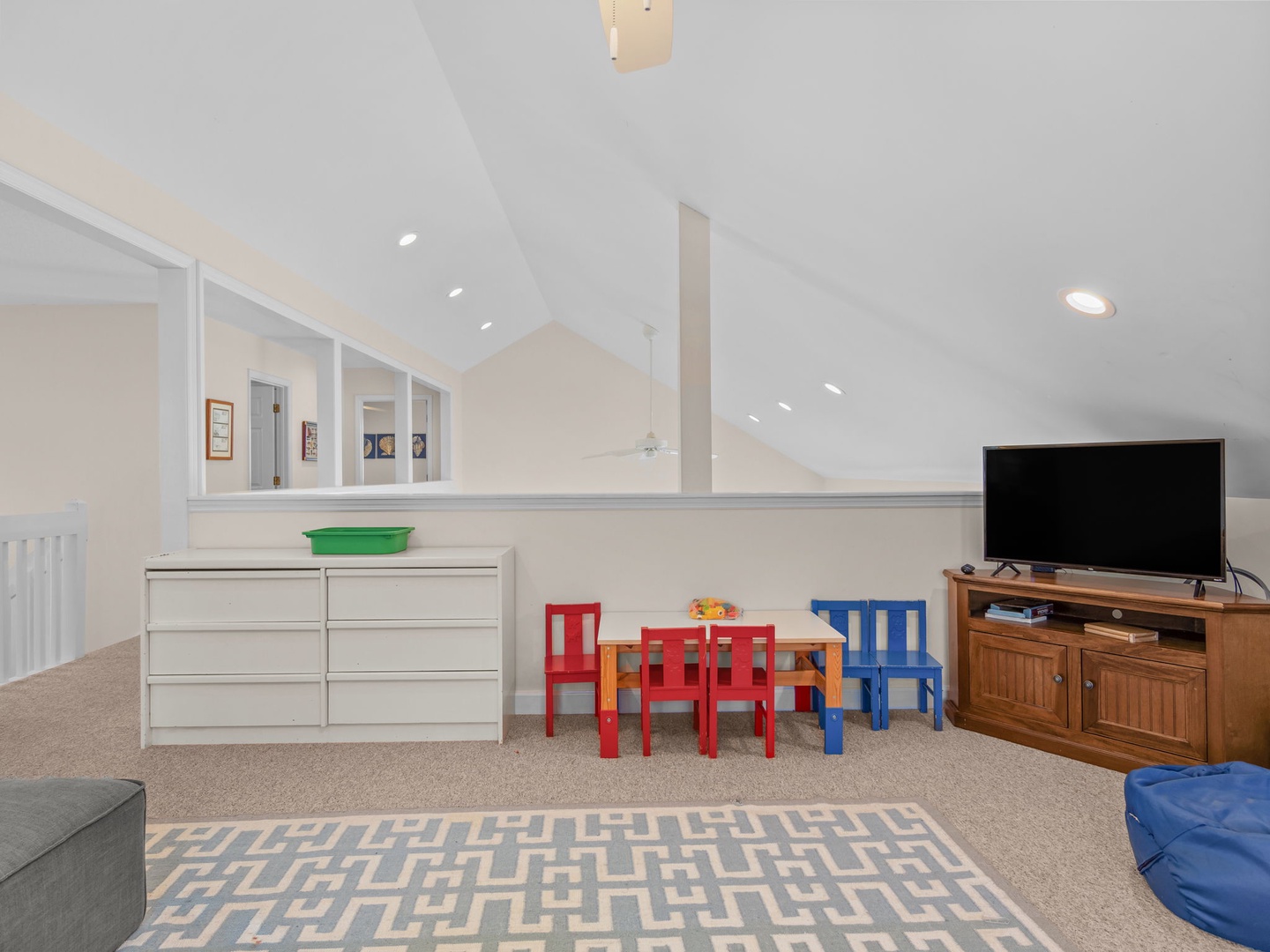 Your kids will love this dedicated play area with colorful furniture, games, and entertainment setup in the bright upstairs loft.