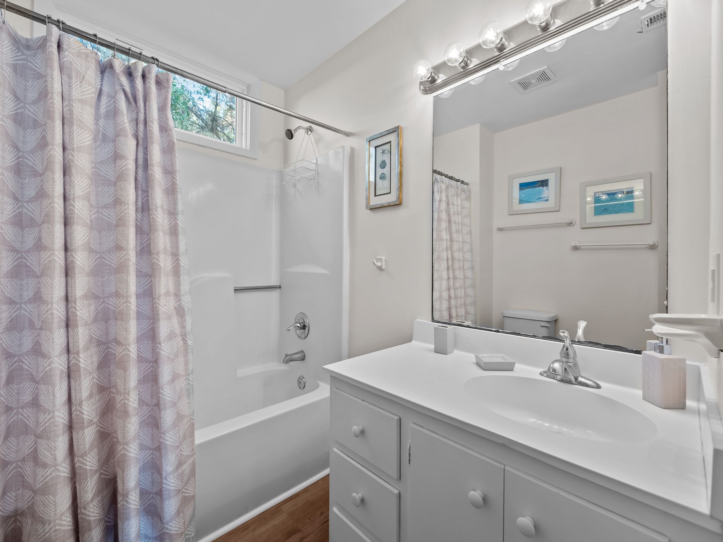 Step into your bathroom with a refreshing shower-tub combo, perfect for unwinding after your adventures.