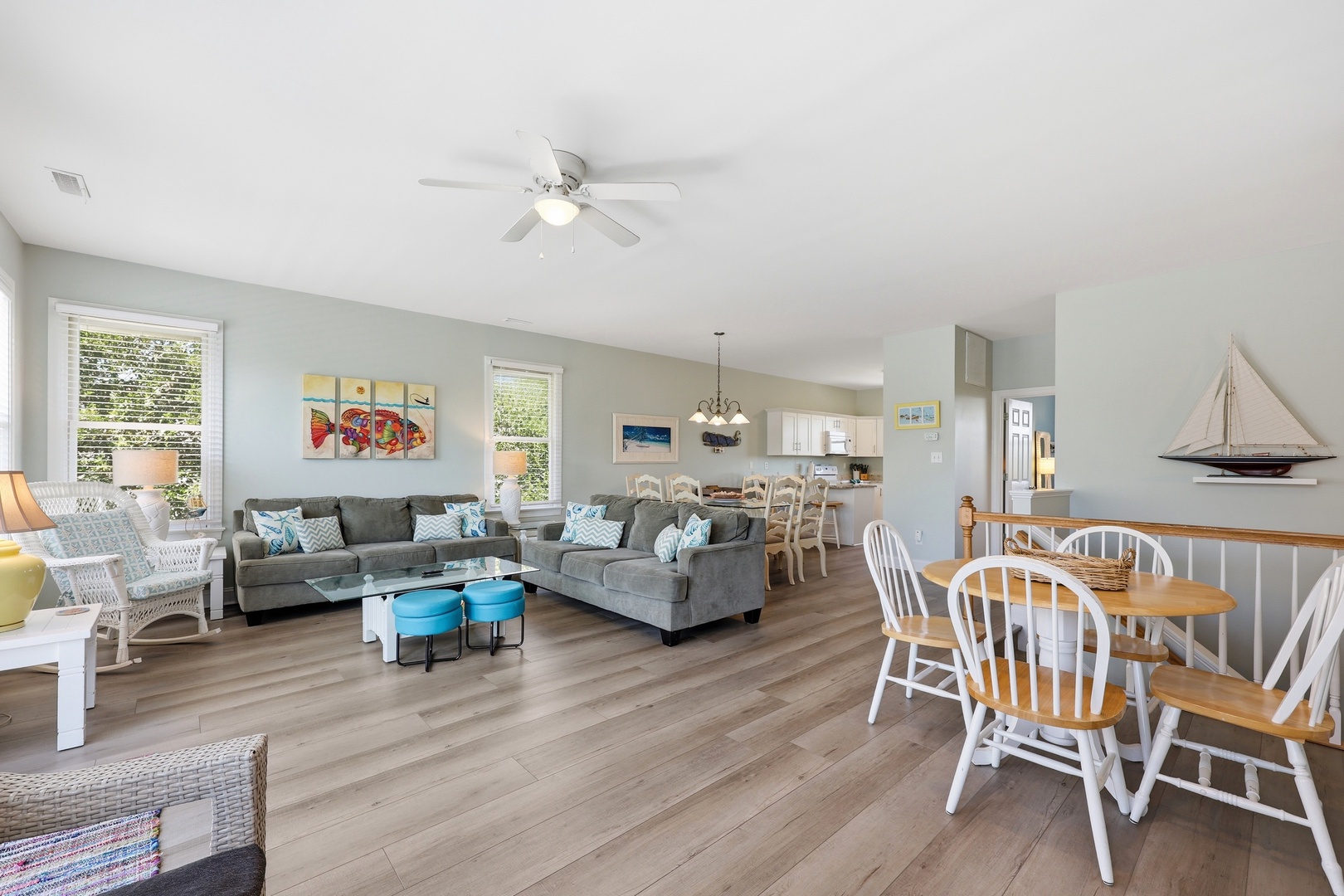 Your bright, open-concept space invites relaxation with coastal charm, plush seating, and warm wood floors that flow seamlessly from lounge to dining and kitchen—perfect for unwinding together.
