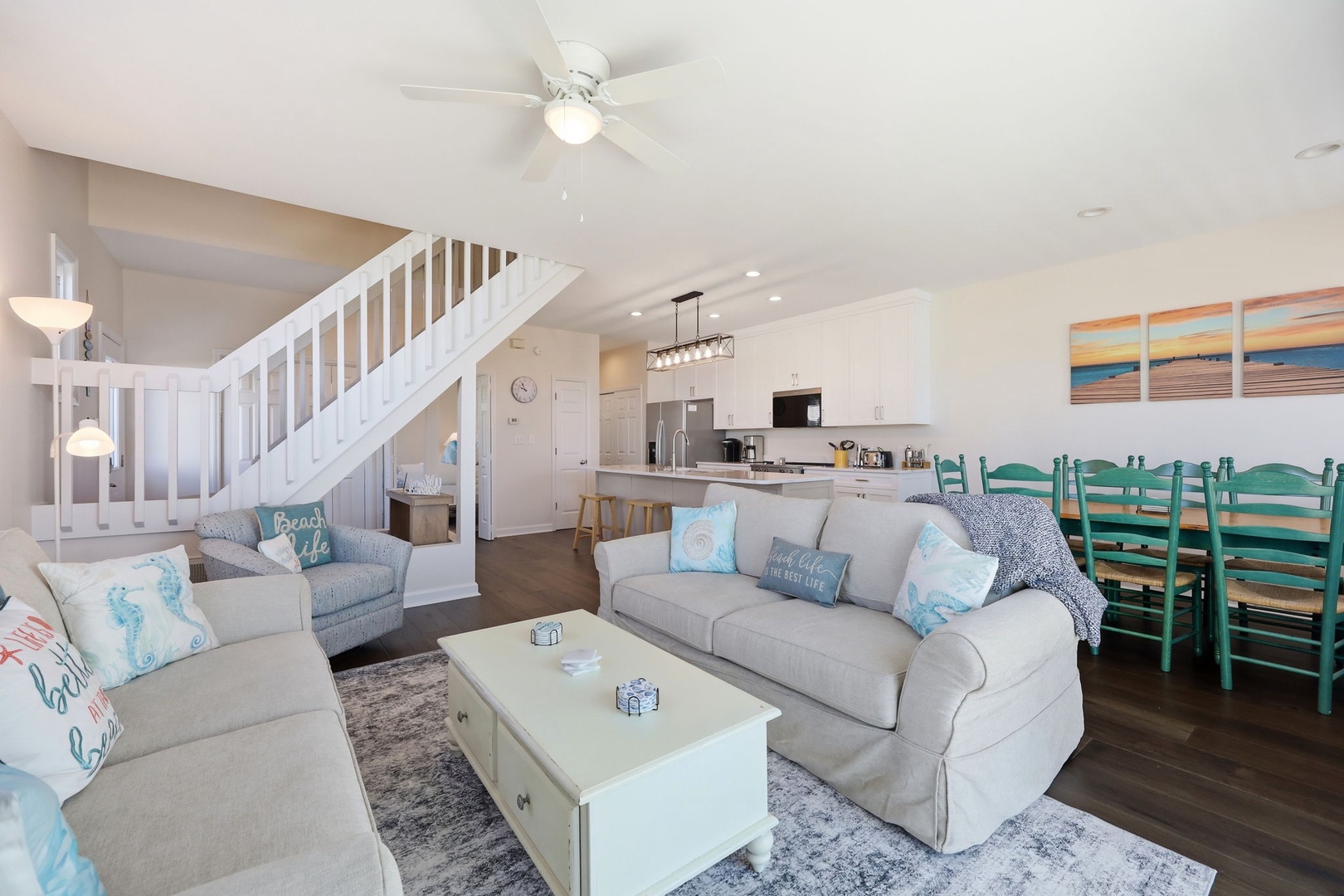 Sink into plush sofas in this bright, airy living space where coastal charm meets comfort. The open layout flows seamlessly into your fully-equipped kitchen and dining area, perfect for togetherness.