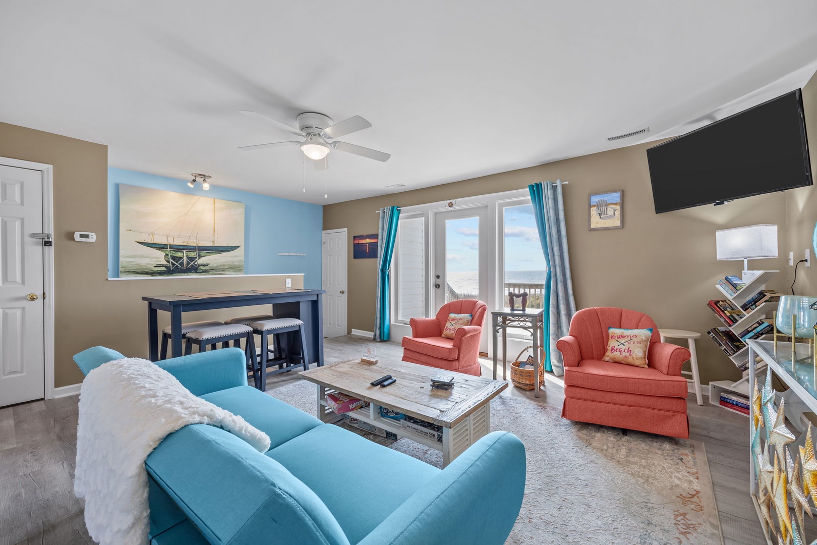 Sink into plush coastal seating while your ceiling fan keeps you cool. The open layout flows perfectly from living to dining areas.