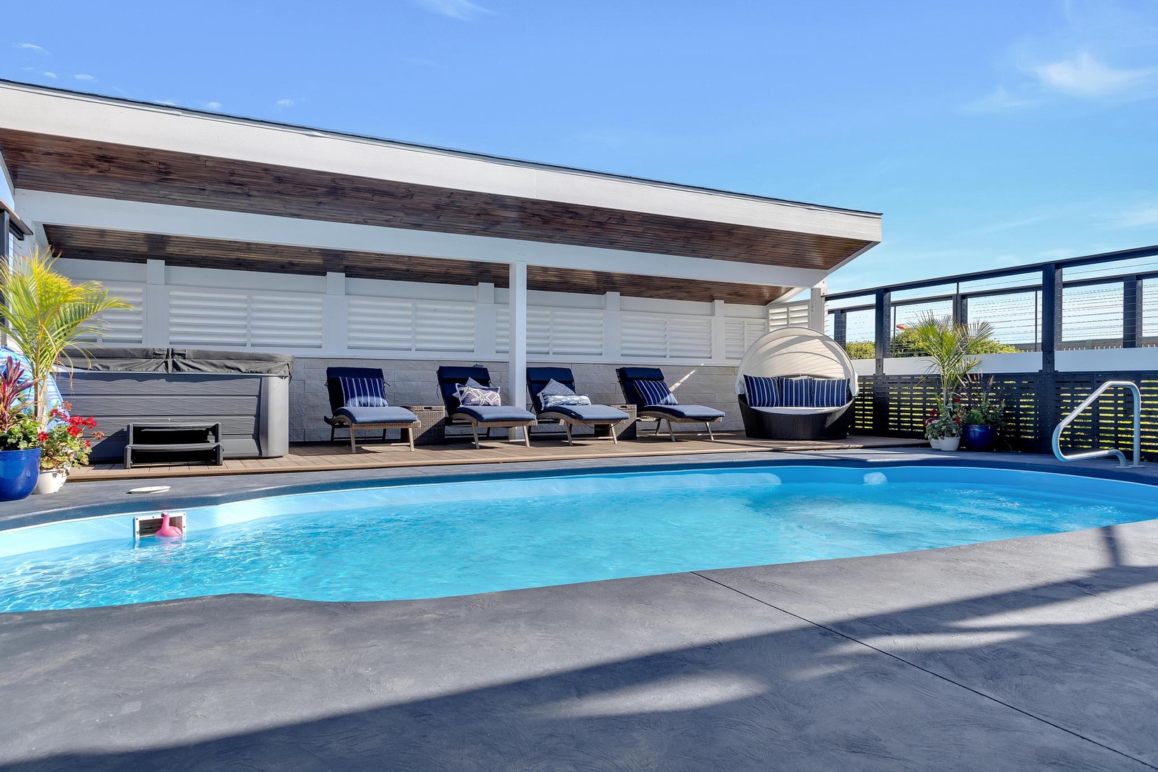 Soak up the sun beside your private pool, perfectly framed by sleek loungers and tropical greenery. This stylish retreat invites you to unwind in serene comfort under open skies.