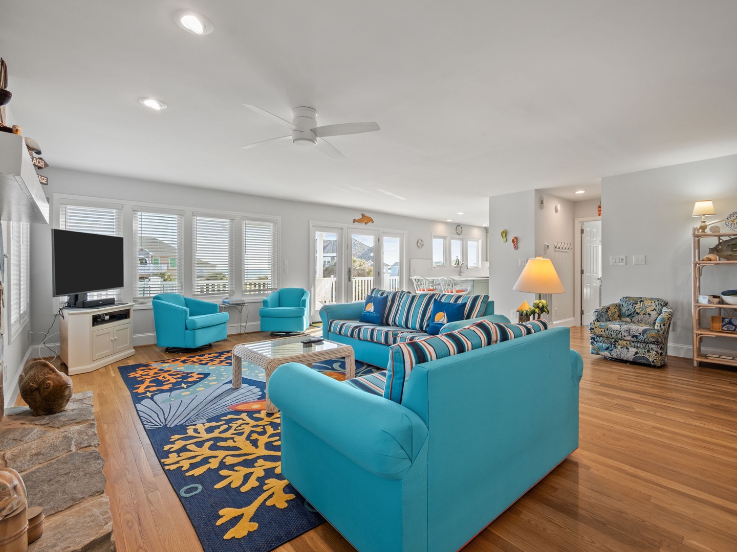 Unwind in your bright coastal living room with ocean-themed decor and comfortable seating for your perfect beach getaway.
