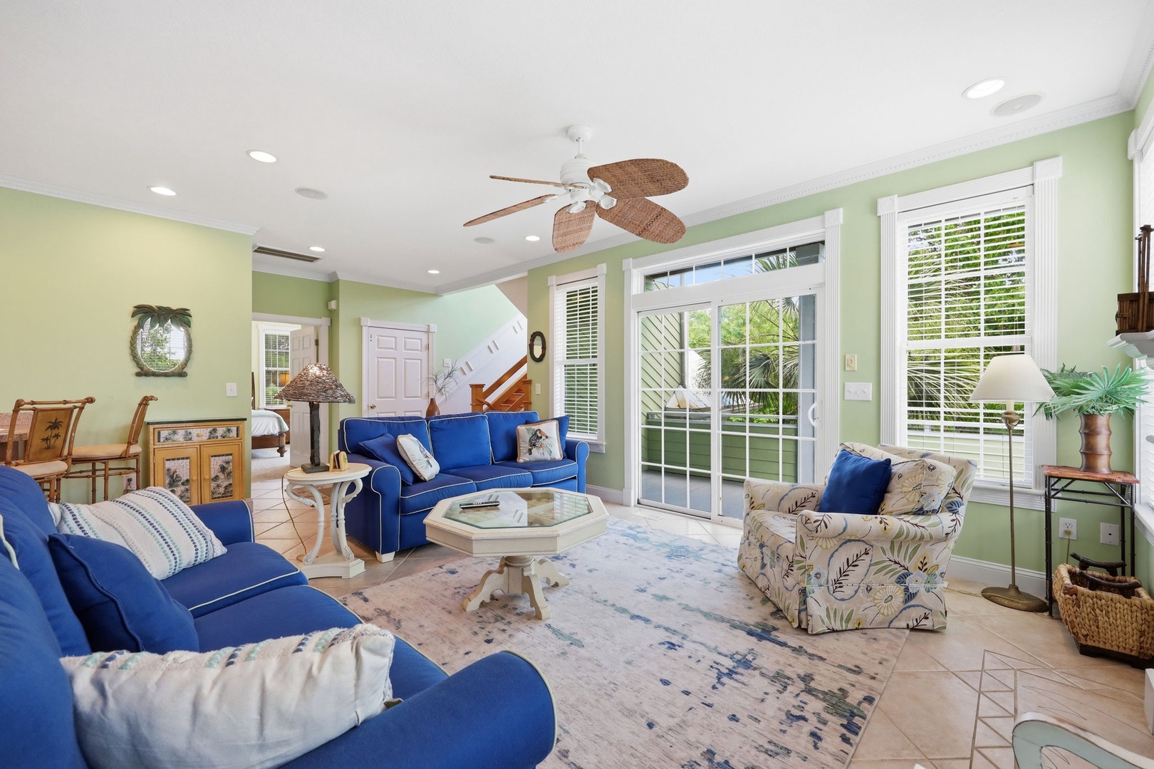 Sink into plush sofas in your bright living space, where tropical breezes drift through glass doors and cheerful colors invite you to truly unwind and feel at home.