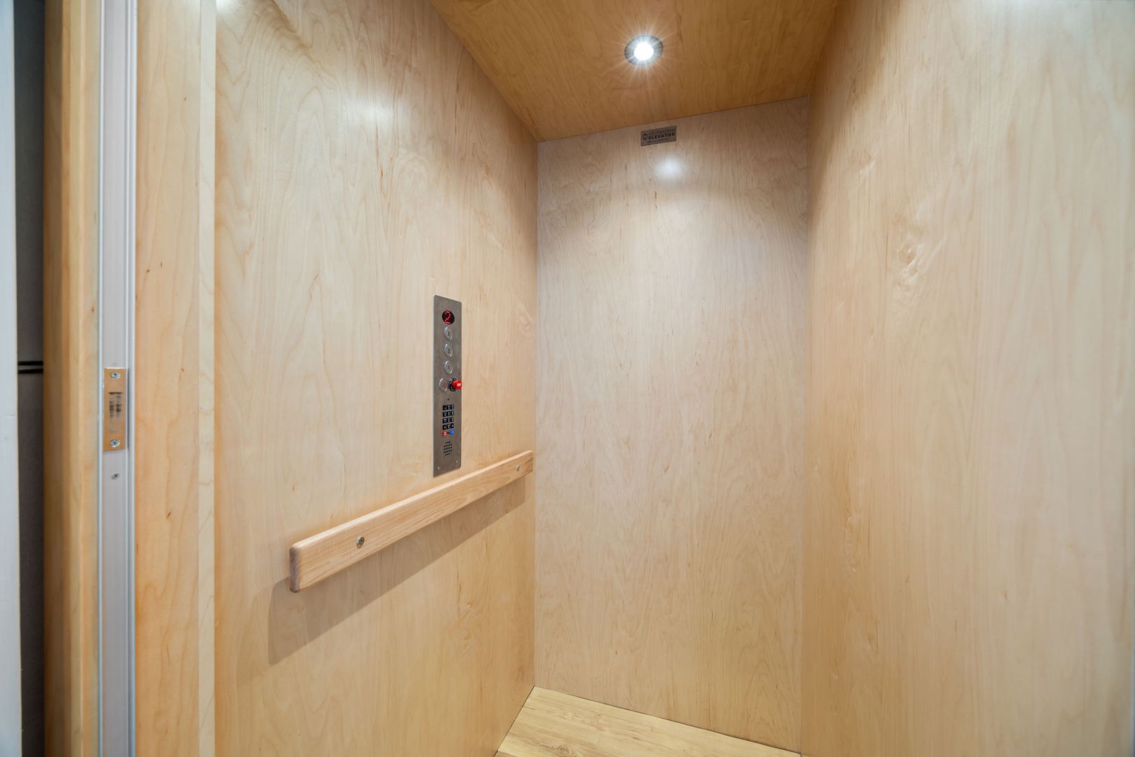 Private elevator with warm wood finishes and modern controls ensures convenient access to your floor.