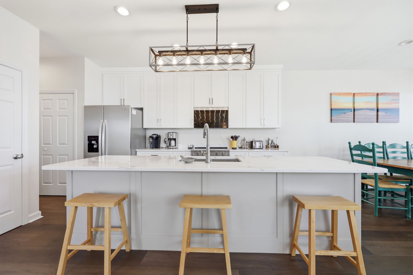 You'll love preparing meals in this bright, open kitchen with its generous island, modern appliances, and soothing coastal touches throughout.