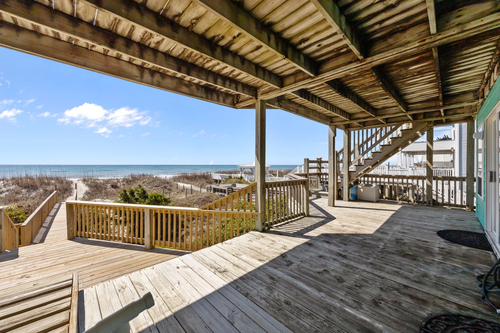 Expansive oceanfront deck with stunning sea views and direct beach access.