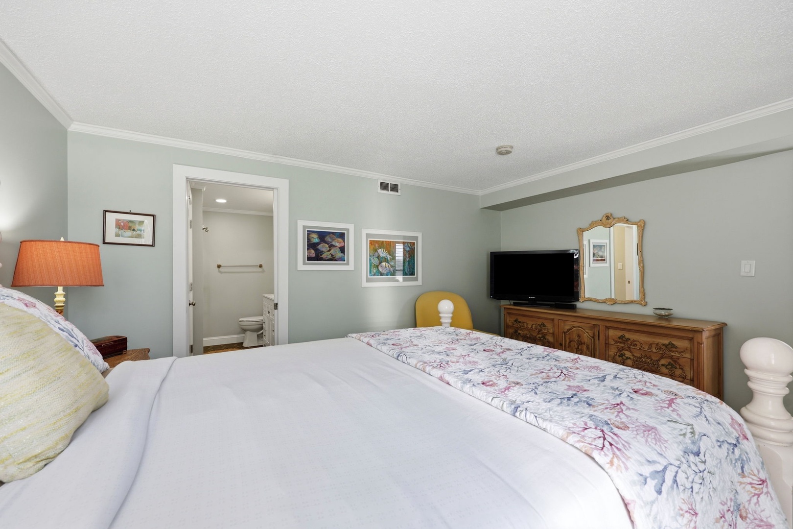 Unwind in your calming bedroom, where soft sage walls and crisp white linens create a peaceful retreat after a day of exploring. An en-suite bathroom adds convenience to your stay.