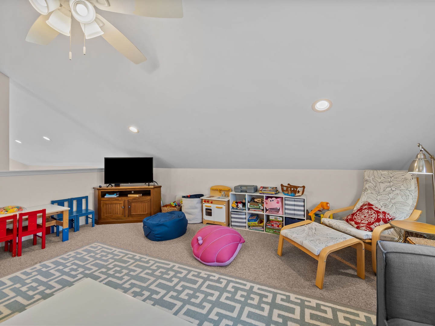 Your family will love this bright playroom with toys, games, and cozy seating for parents to relax while kids play.