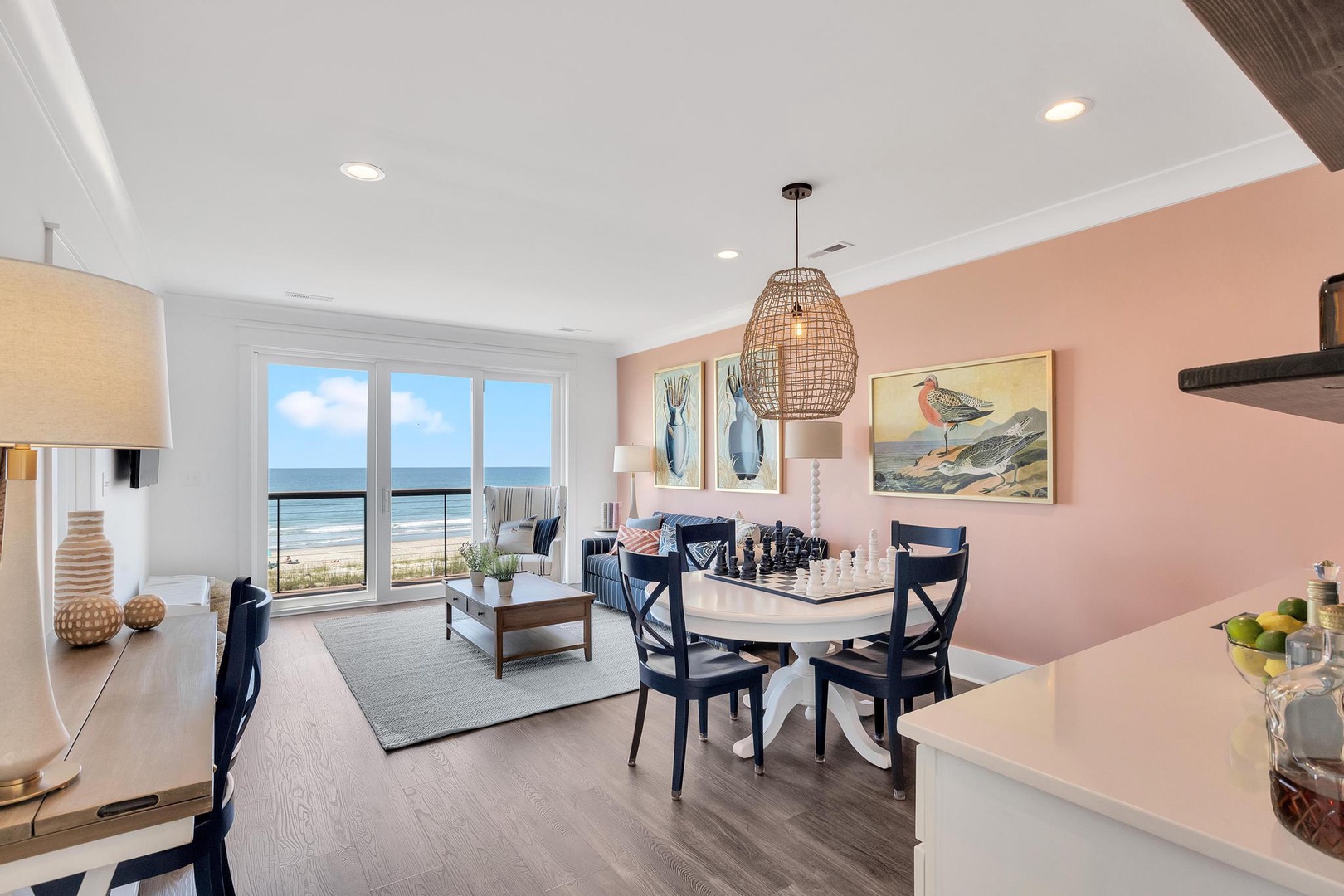 Picture yourself waking to stunning ocean views through expansive windows, where coastal breezes drift into your bright, stylishly appointed space. The open living and dining area invites you to unwind, share meals, and soak in beachfront serenity.