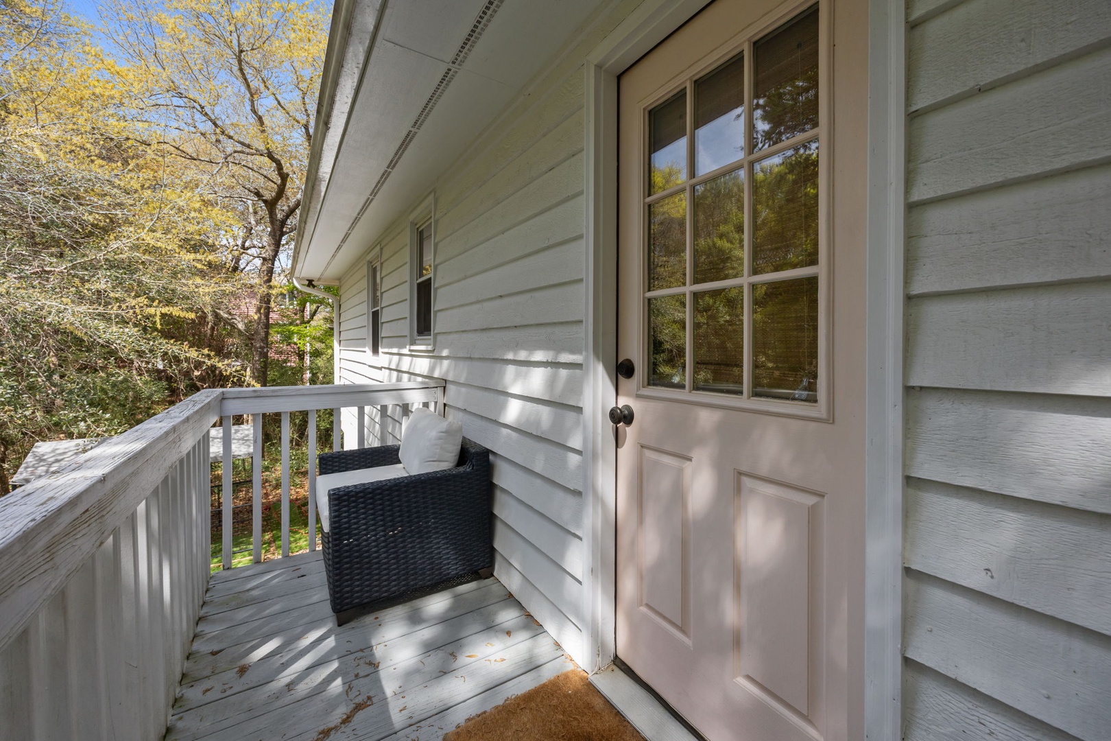Step onto your private entrance deck surrounded by beautiful autumn foliage and natural light streaming through classic windows.