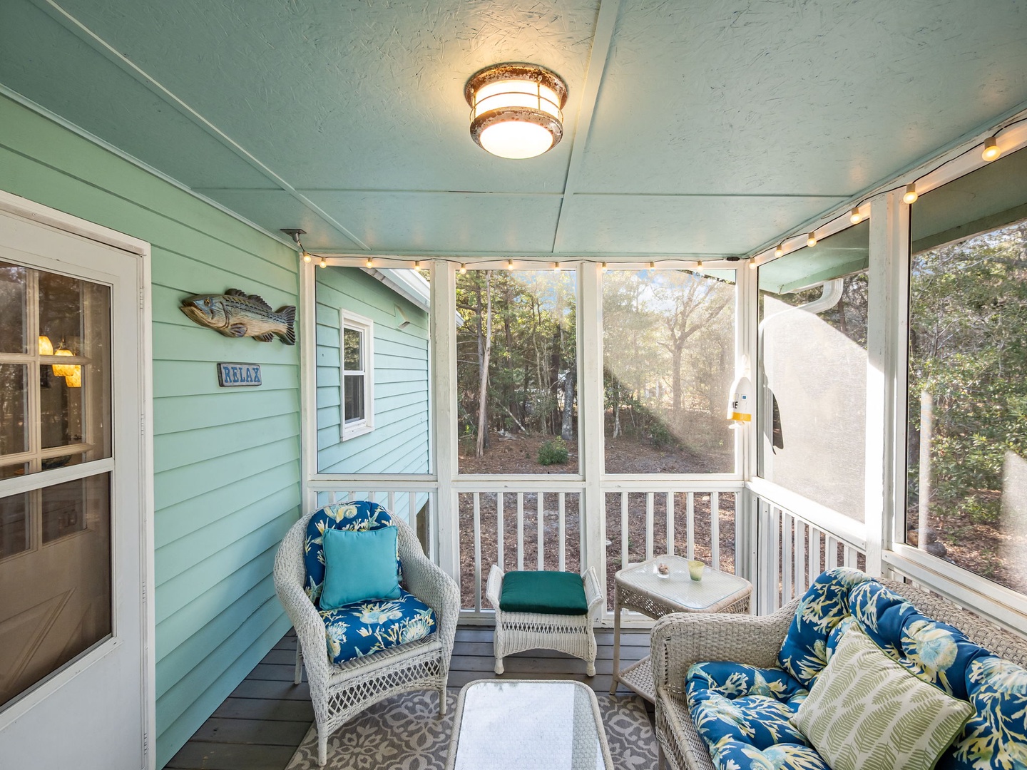 Settle into your screened porch sanctuary with plush wicker seating and tropical cushions, perfect for your morning coffee or evening unwind.