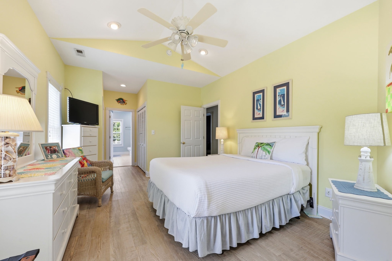 Drift off to sleep in your cheerful, sunlit bedroom with crisp linens, gentle ceiling fan breezes, and coastal décor creating a calming retreat after your day.