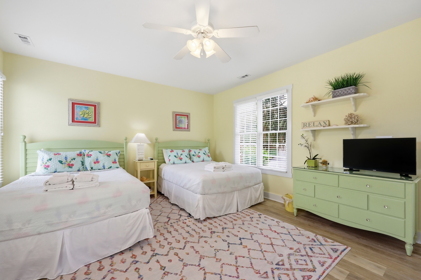 Unwind in your peaceful retreat with two plush beds, cheerful décor, and soft natural light inviting you to relax and recharge after a day of adventure.