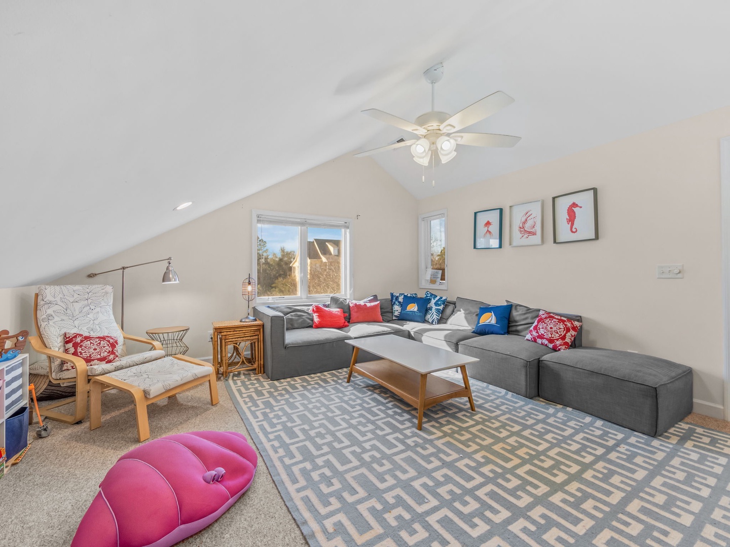 Relax in your spacious loft living room with vaulted ceilings, comfy sectional seating, and cheerful coastal touches.