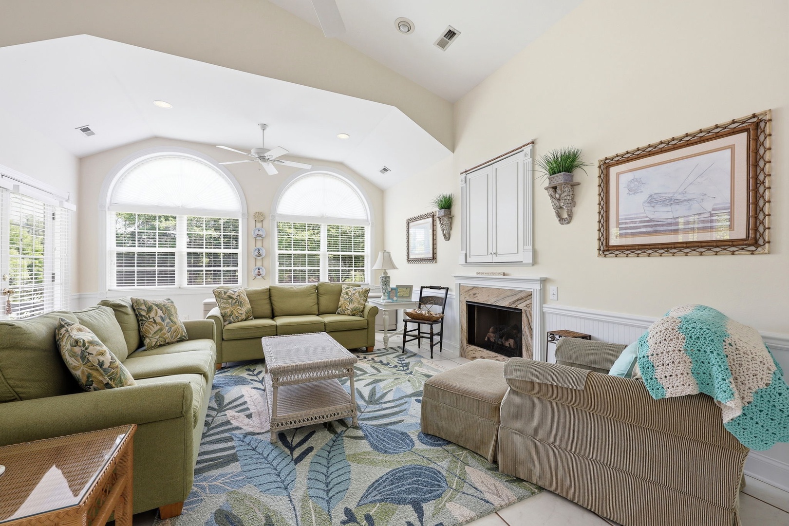 Settle into your serene retreat with soaring ceilings and abundant natural light. Relax by the fireplace or gather with loved ones in this bright, welcoming space designed for comfort and connection.