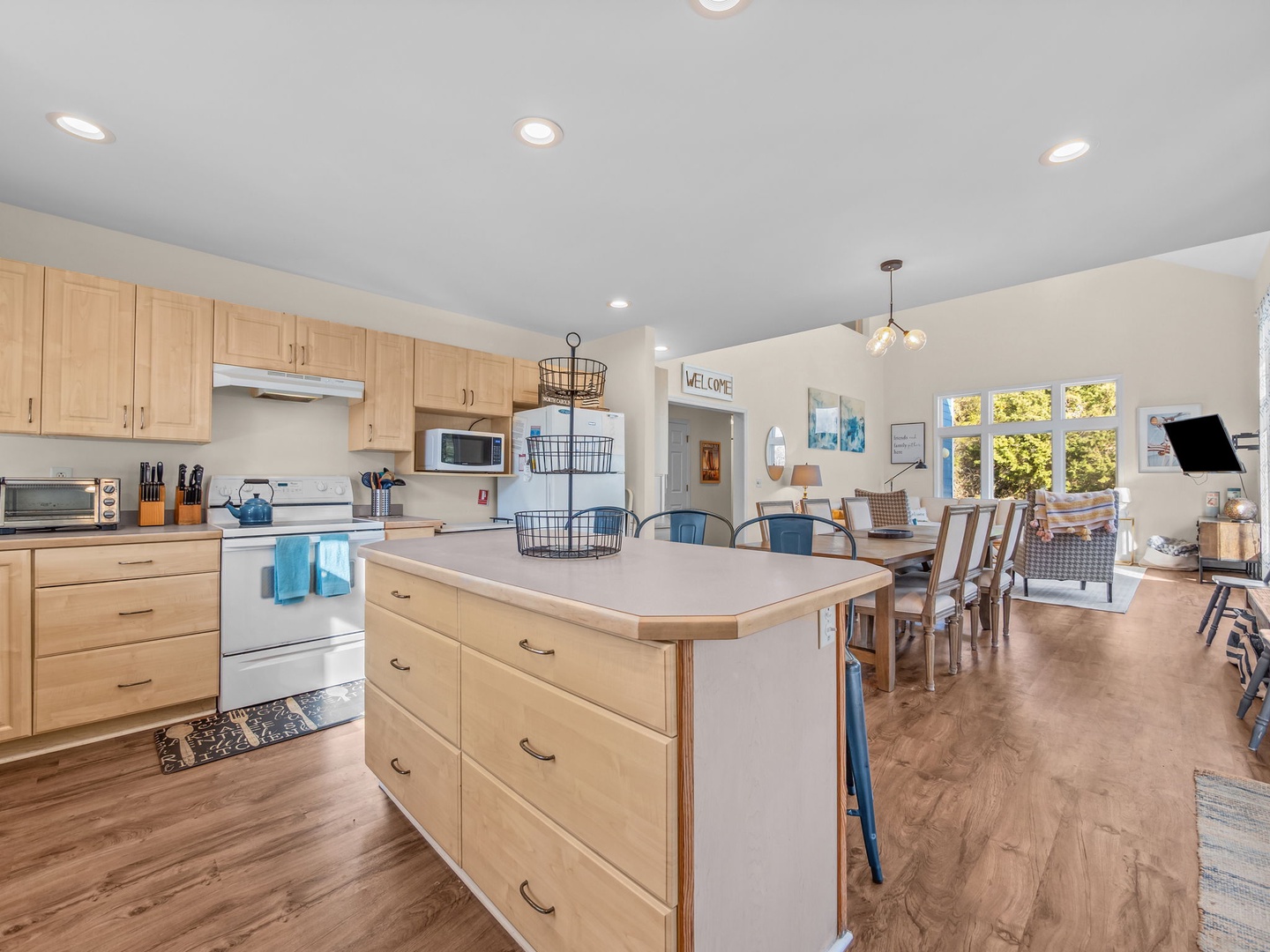 Your bright open-concept kitchen features warm wood cabinets and flows seamlessly into the dining and living areas—perfect for gathering.