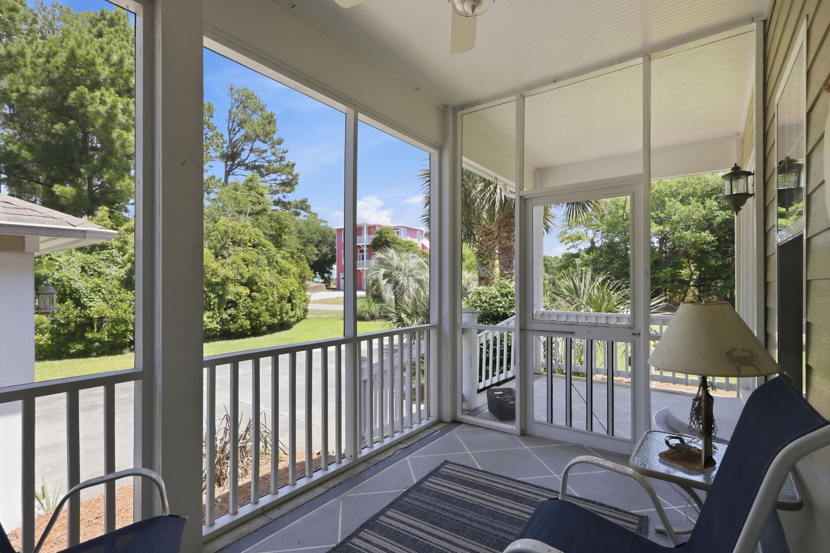 Relax on your screened porch with views of lush greenery and palms. Enjoy morning coffee or unwind at dusk in this bright, breezy space—perfect for savoring peaceful moments outdoors.