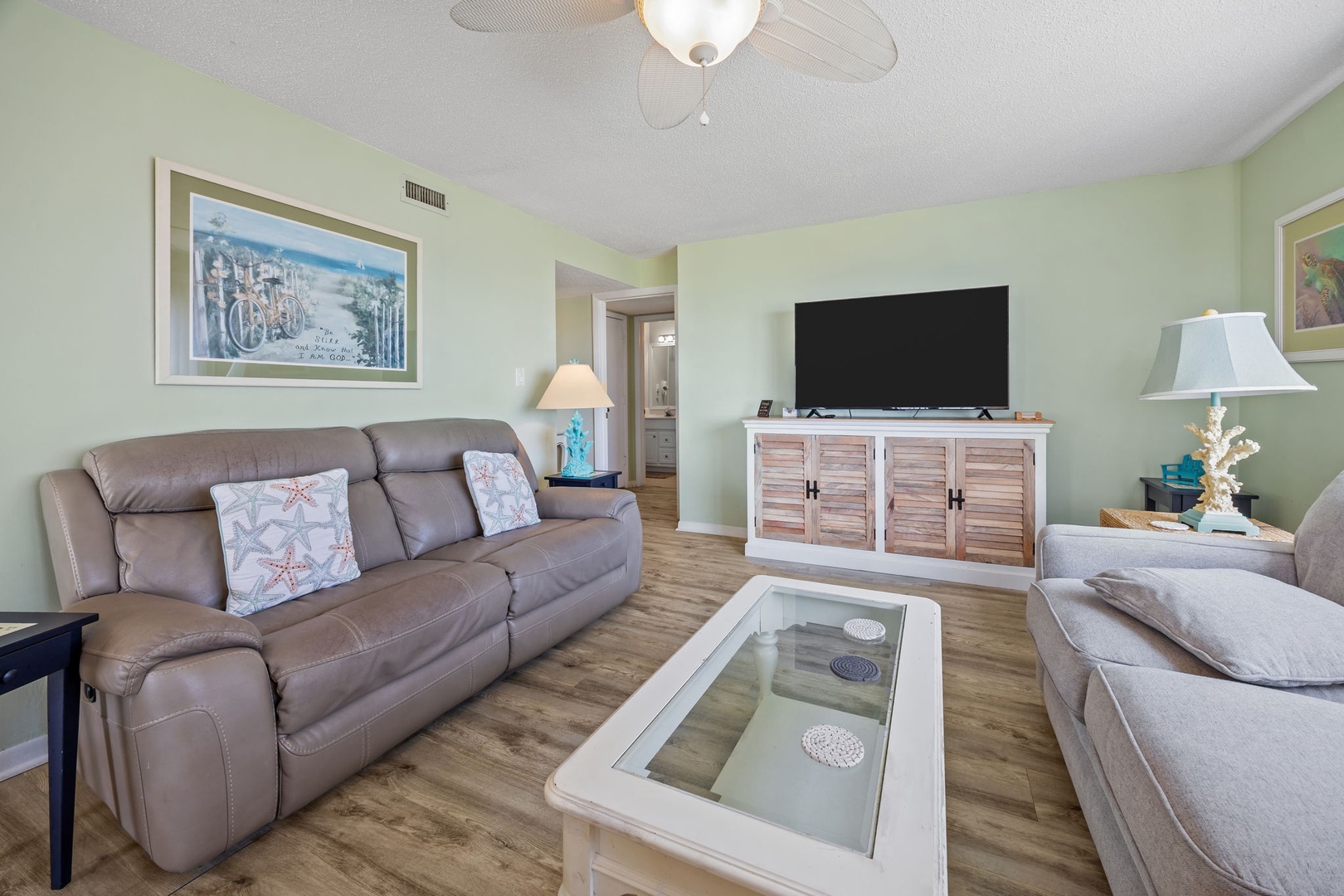 Sink into plush leather sofas while cool ocean breezes from the ceiling fan create your perfect retreat atmosphere.