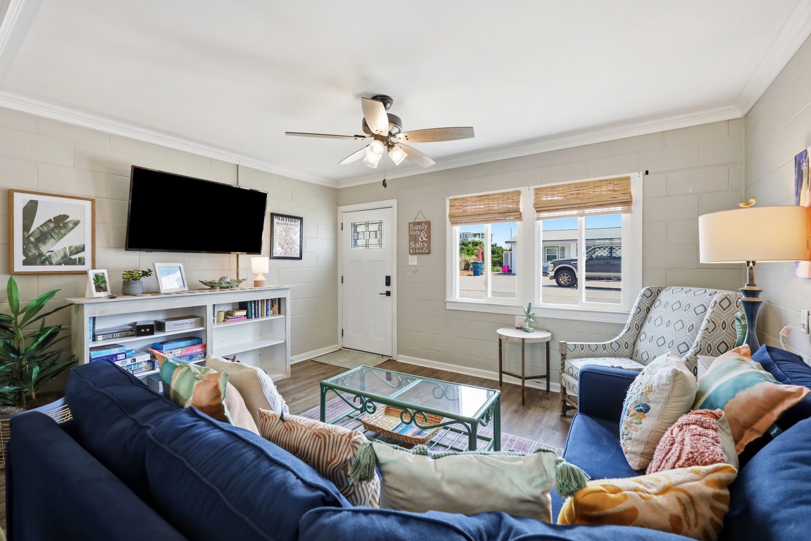 Sink into plush sofas and unwind in your bright, welcoming living space, where a ceiling fan keeps you comfortable and cheerful décor sets the perfect tone for relaxation.