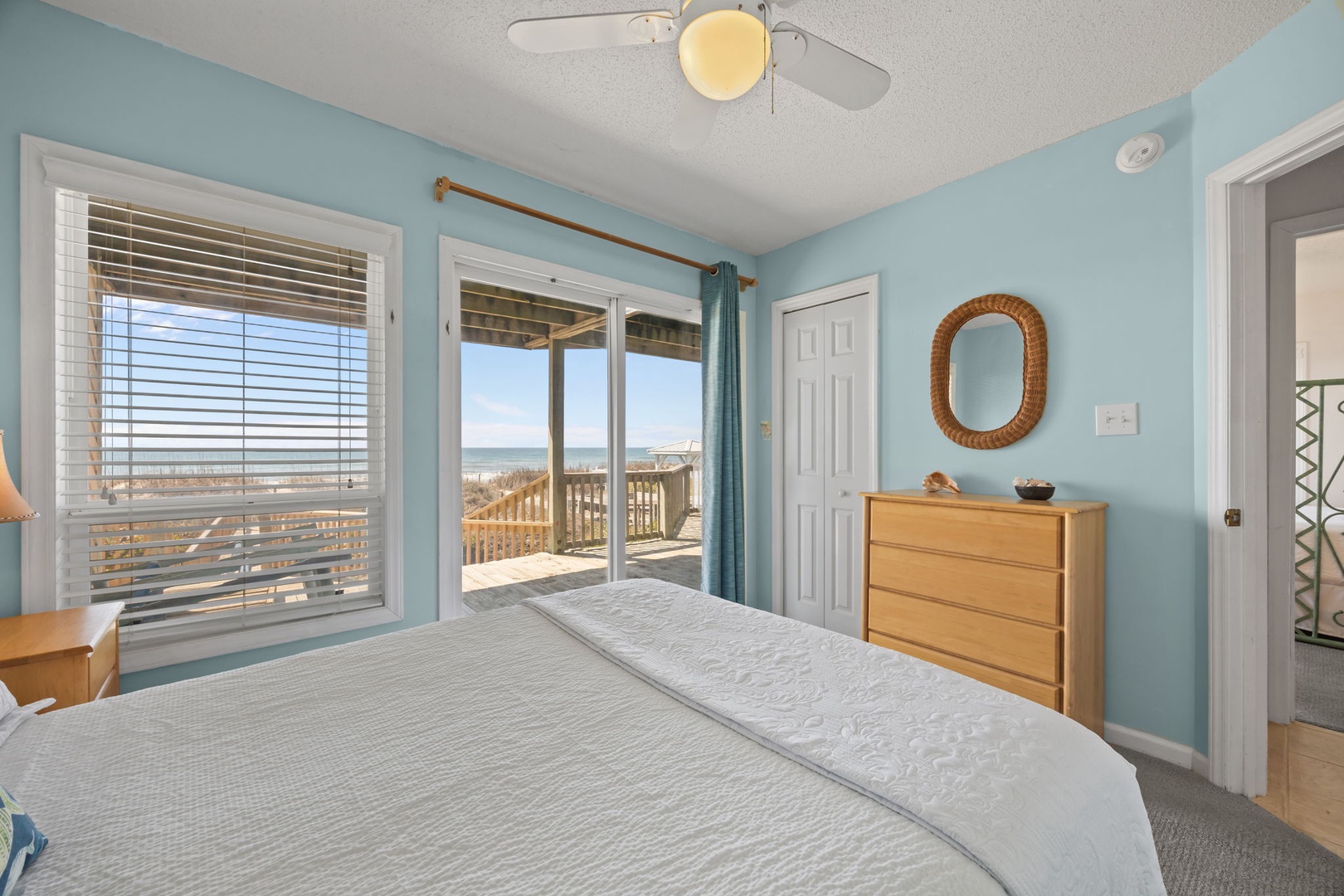 Wake up to stunning ocean views from your serene bedroom with direct beach access. Drift to sleep with sea breezes flowing through sliding doors.