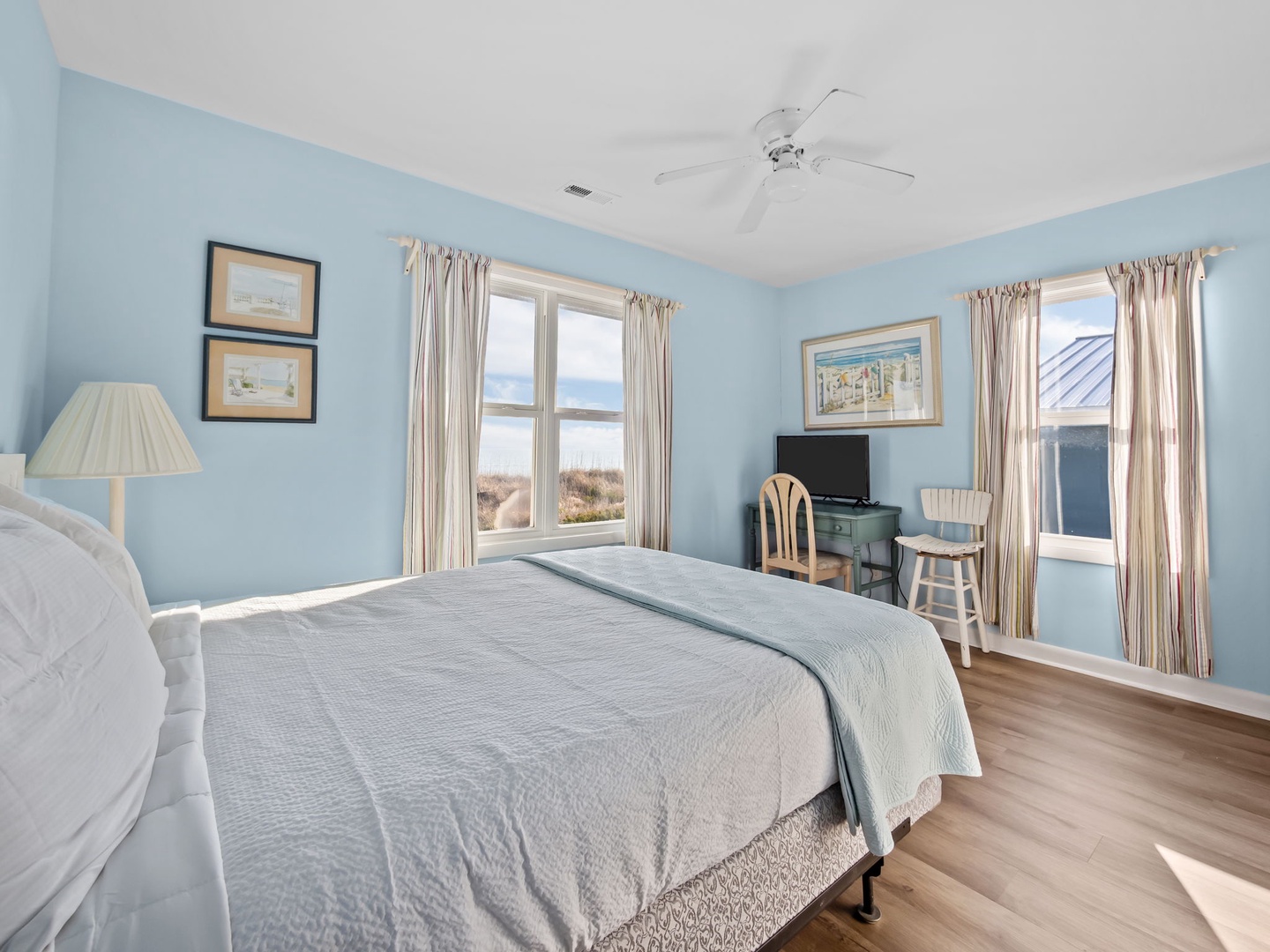 Wake up in your serene Queen bedroom with ocean glimpses through the windows.