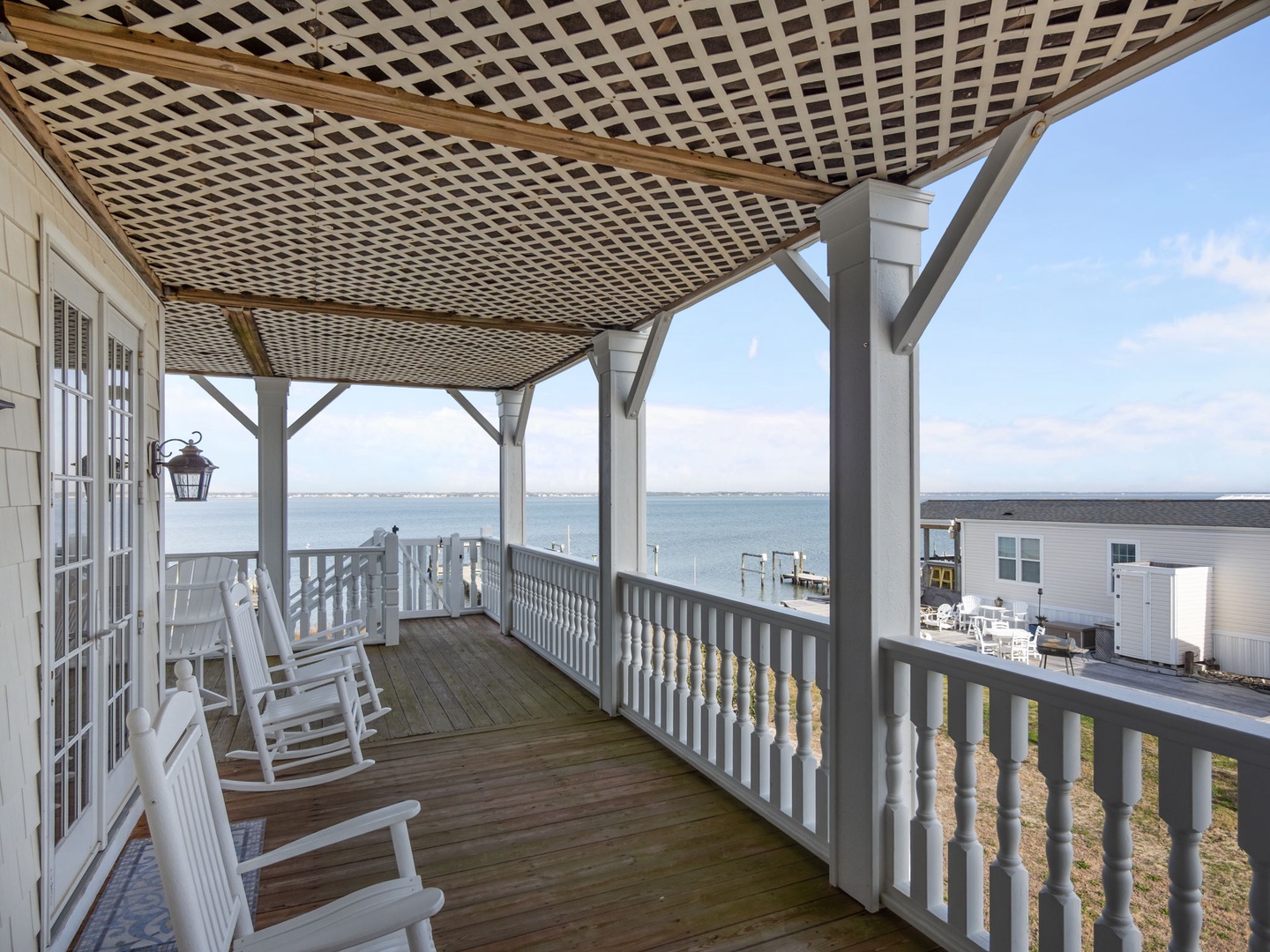 Relax in your private rocking chairs on this covered waterfront porch, where stunning sound views stretch endlessly before you.