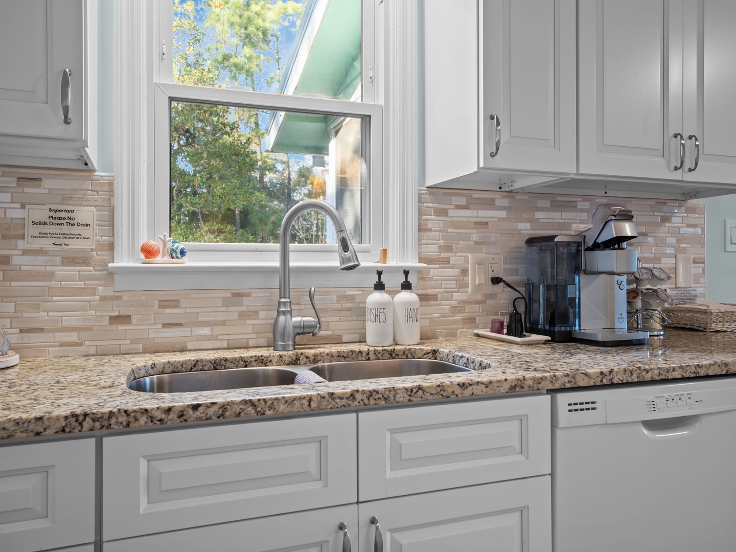 Your fully equipped kitchen features granite countertops, modern appliances, and a garden view window for cooking with natural light.