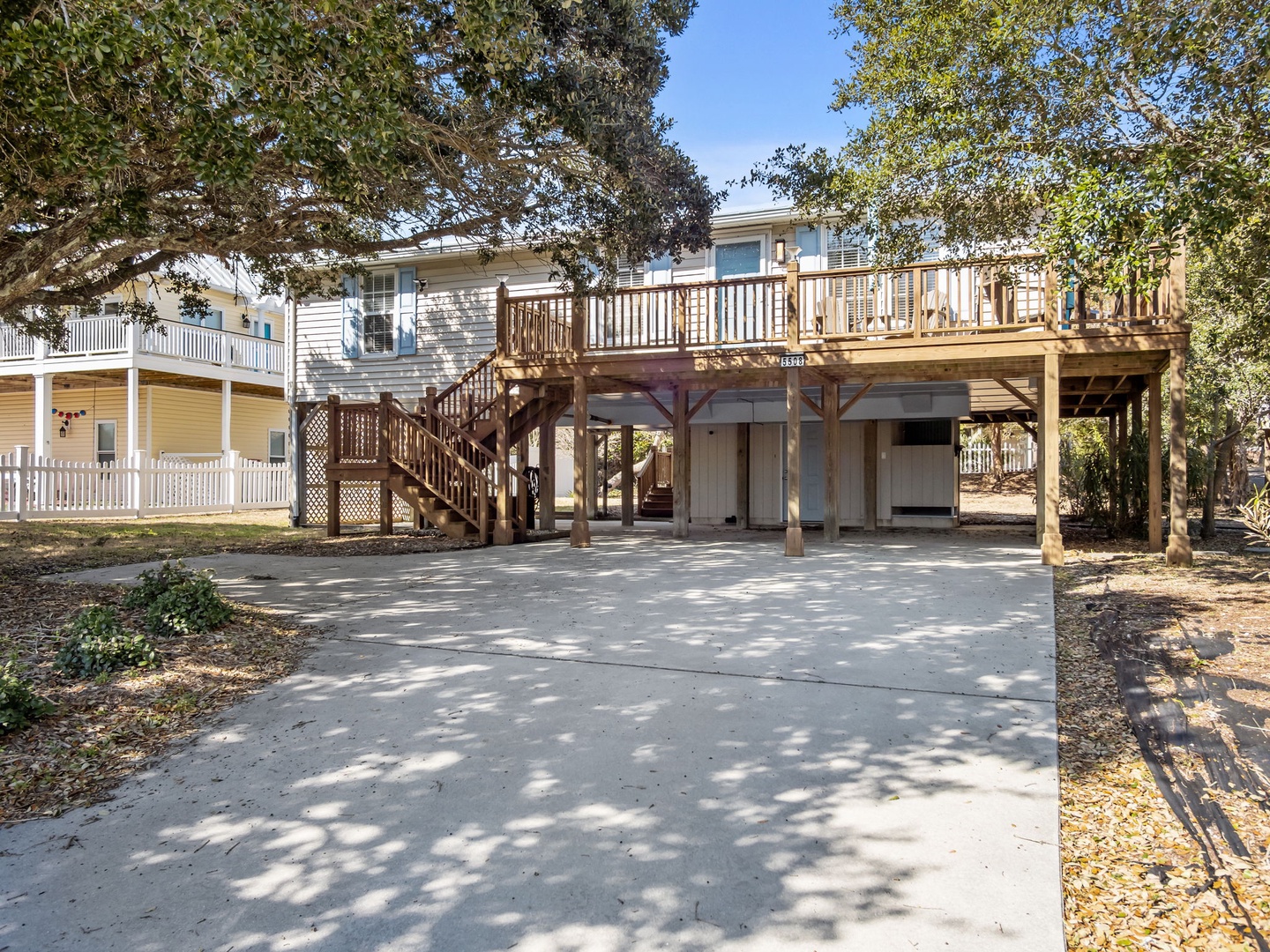 Charming elevated beach house with spacious parking and covered ground-level storage beneath your private deck retreat.