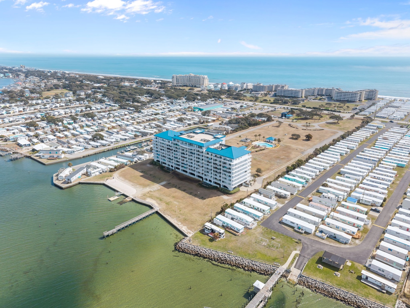 Aerial view of the coastal property with direct bay access and beachfront location in a vibrant waterfront community.