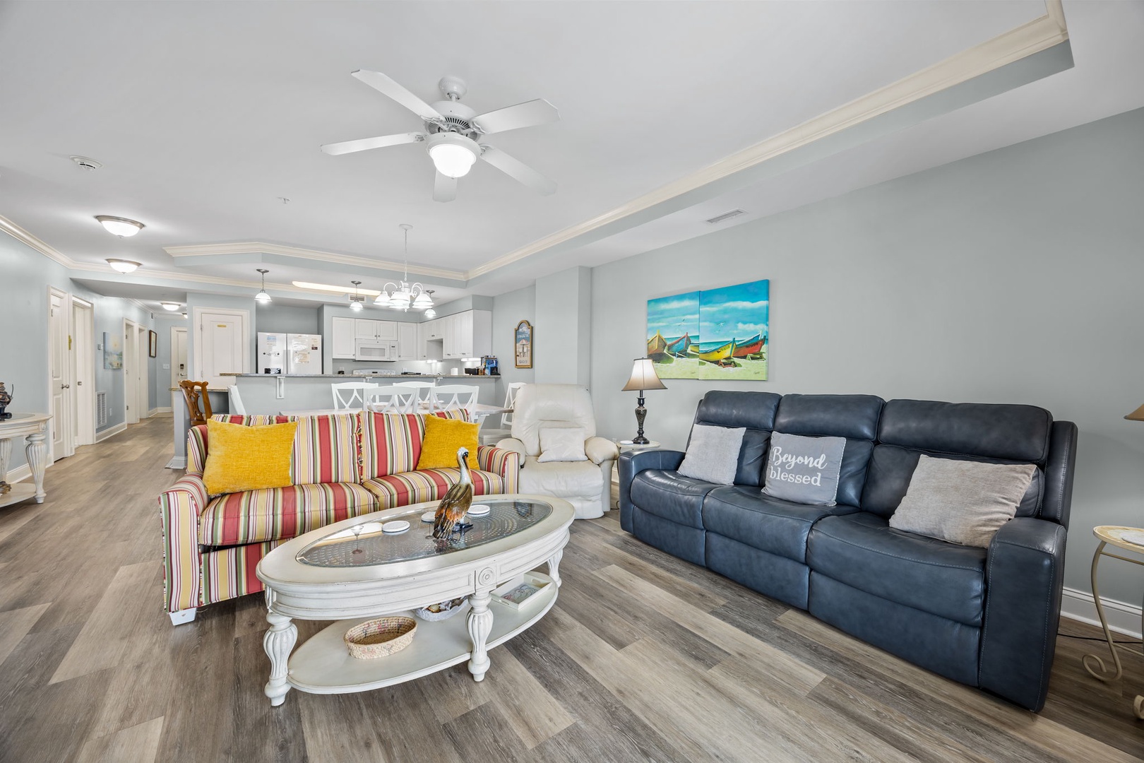 Relax in your bright living space with colorful coastal charm, modern comforts, and an open layout perfect for gathering together.
