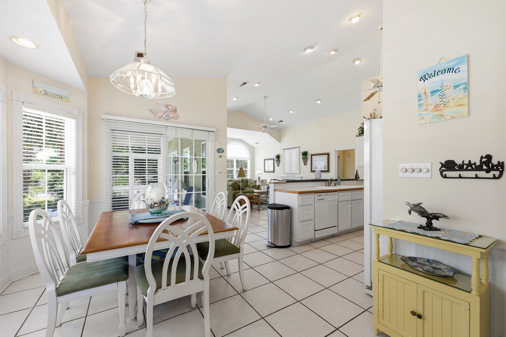 Gather around this inviting dining table where your mornings start with coffee and conversation. The open kitchen flows seamlessly into the living area, giving you plenty of room to cook, relax, and make vacation memories together.