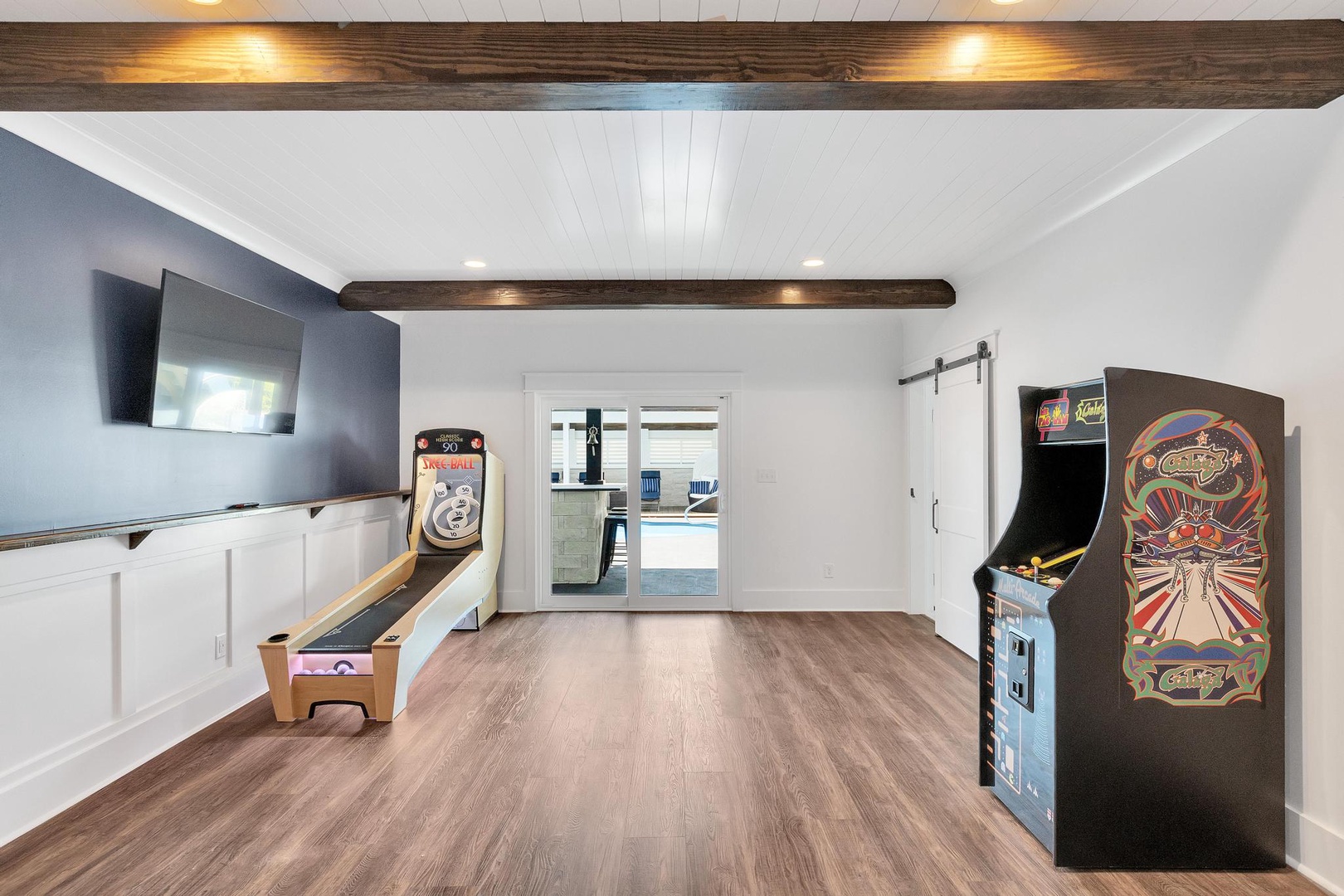 Enjoy friendly competition in your private game room with vintage arcade games, skeeball, and a large TV—perfect for family fun or group entertainment.
