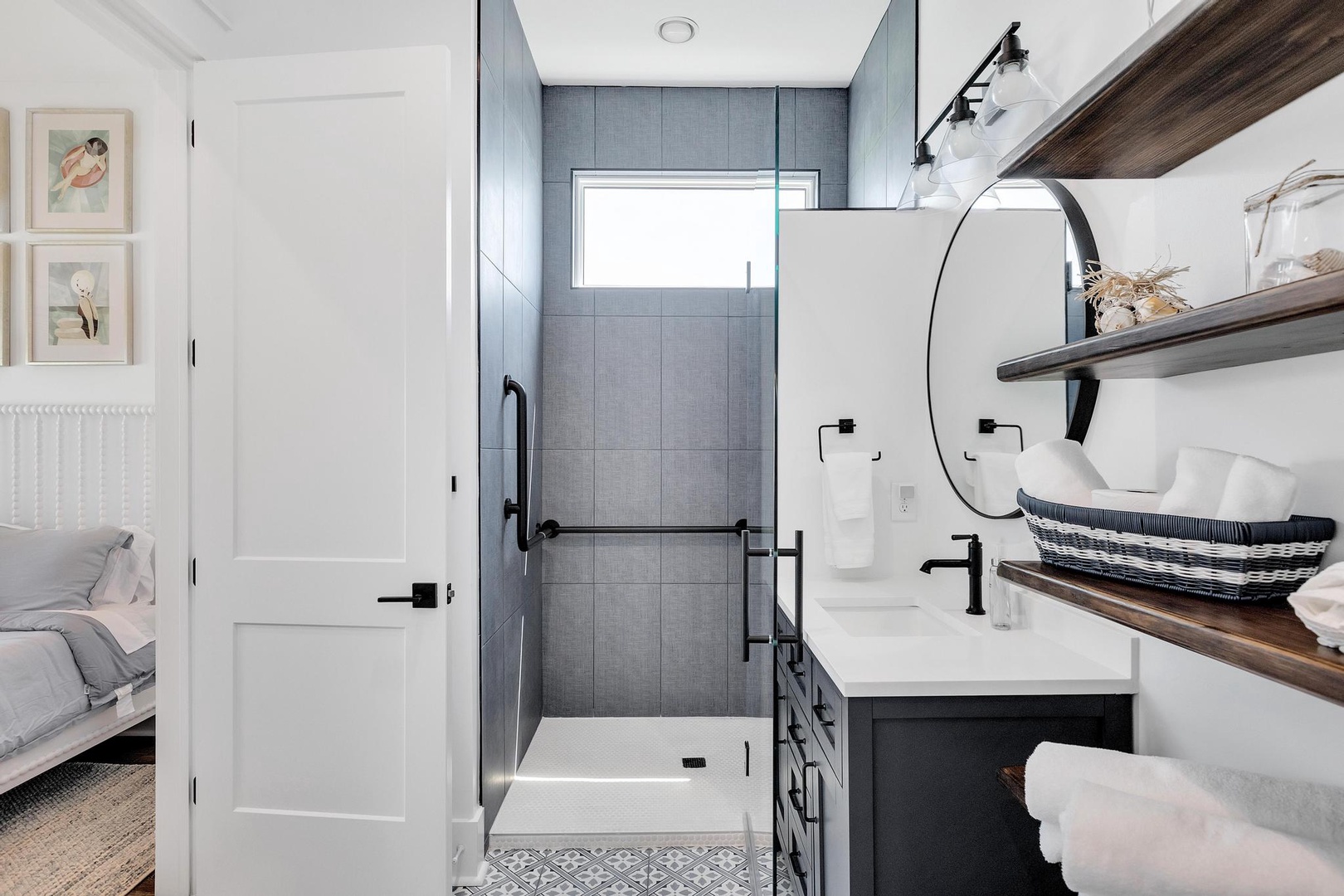Your en-suite bathroom blends modern elegance with thoughtful design—crisp white fixtures, sleek black accents, and a spa-like walk-in shower await your morning refresh.