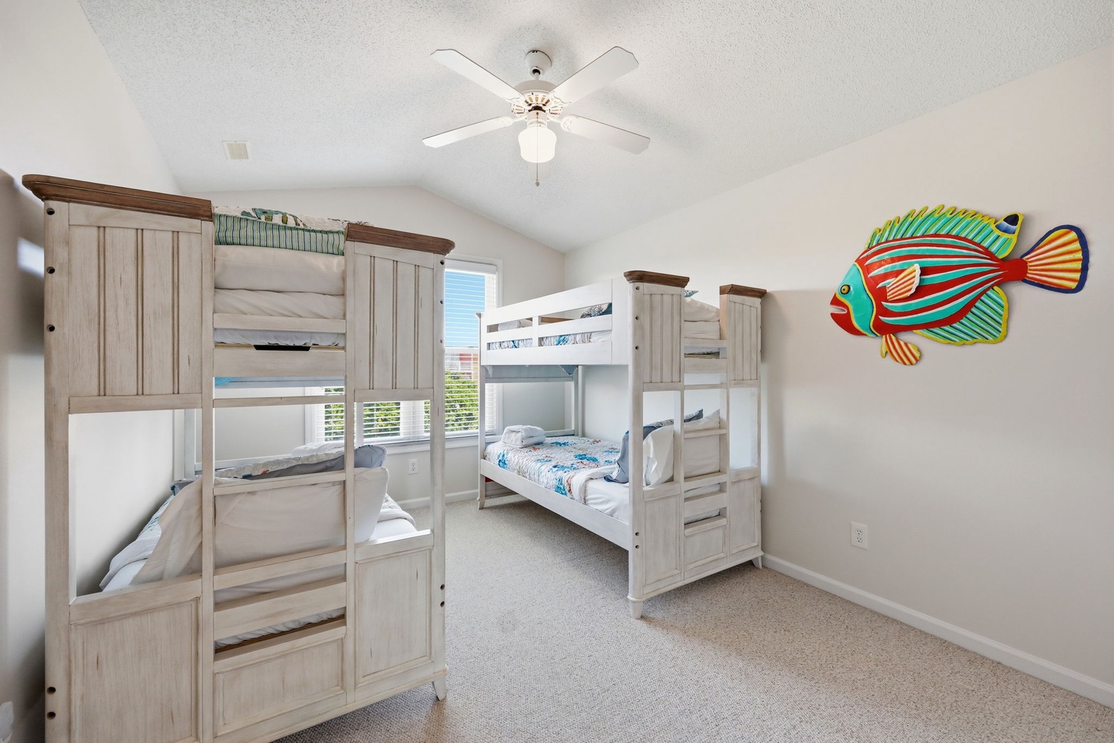 Your kids will love bunking together in this cheerful, beach-themed bedroom, where the colorful tropical fish and bright space invite endless fun and restful sleep.
