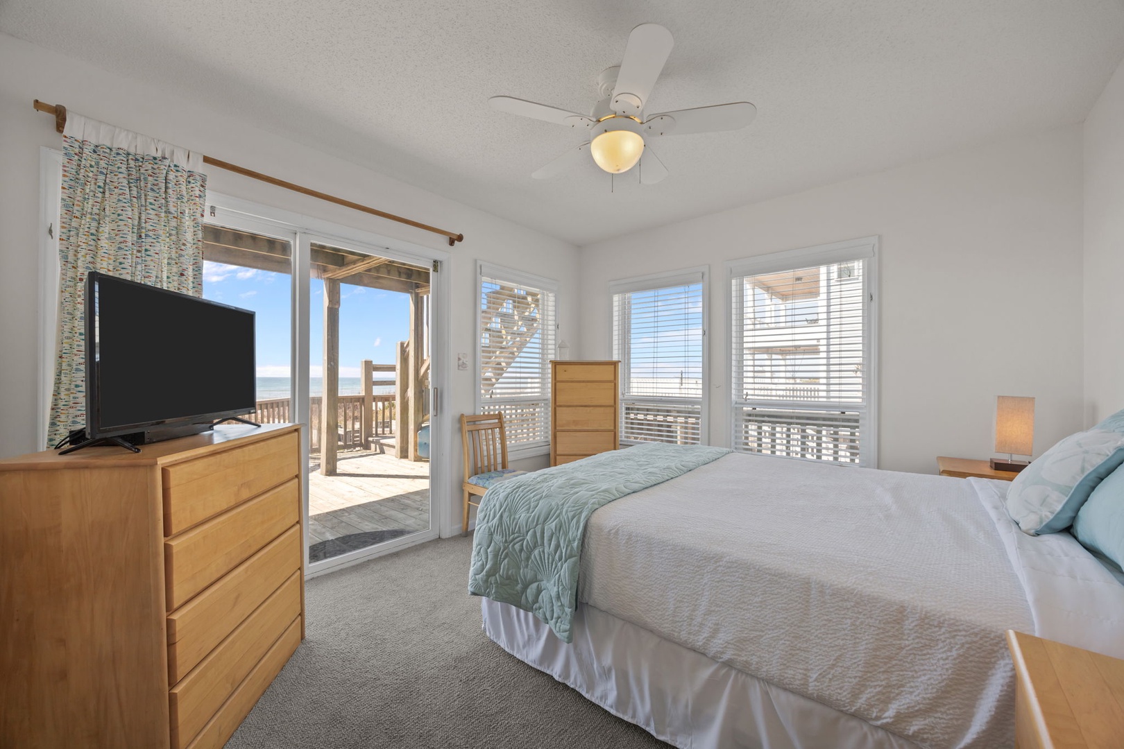 Wake up to stunning ocean views from your cozy bedroom, where gentle sea breezes flow through sliding doors to your private balcony.