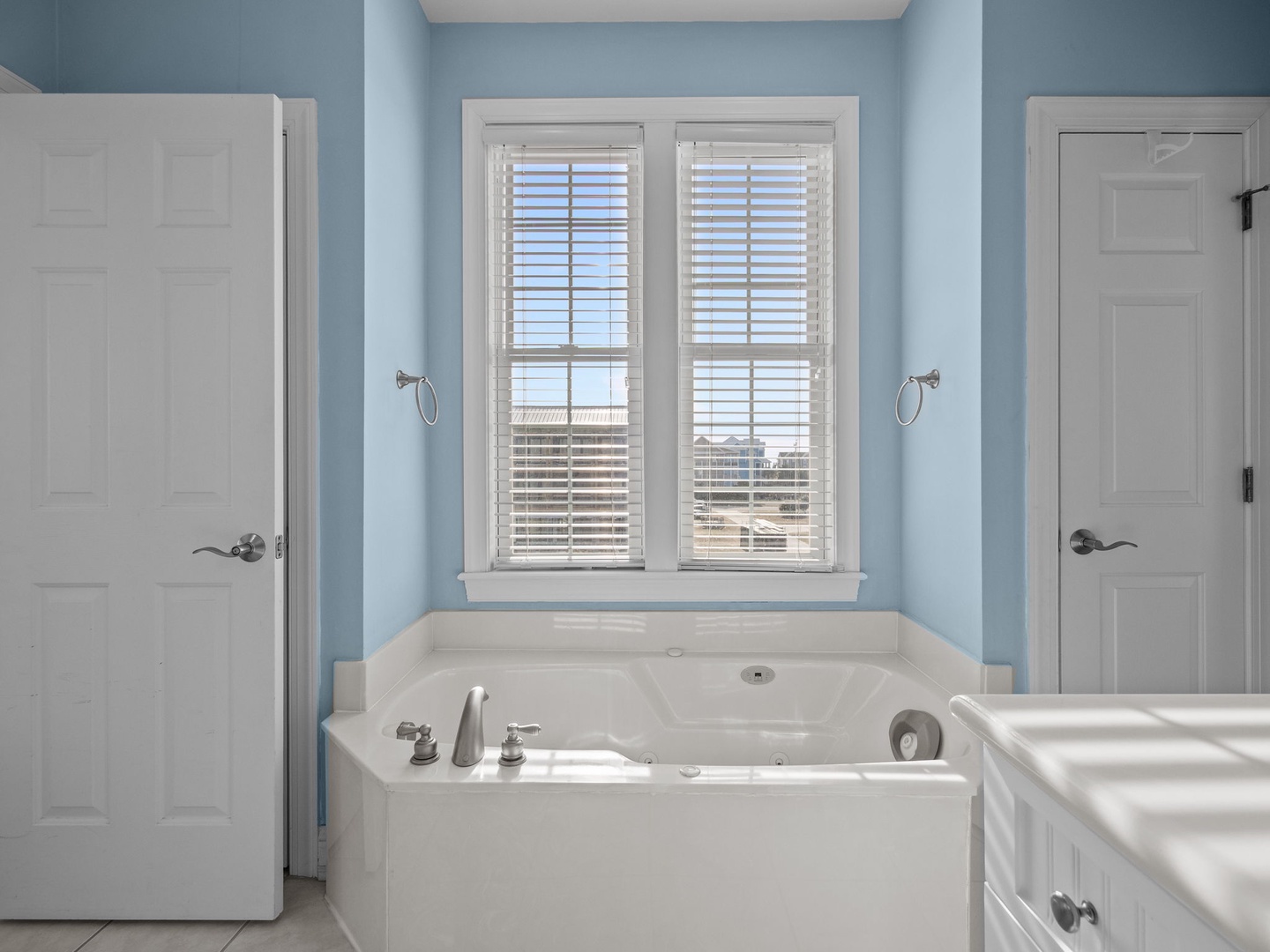 Soak away your worries in this spacious master bathroom tub, perfectly positioned beneath windows for natural light during your relaxing retreat.